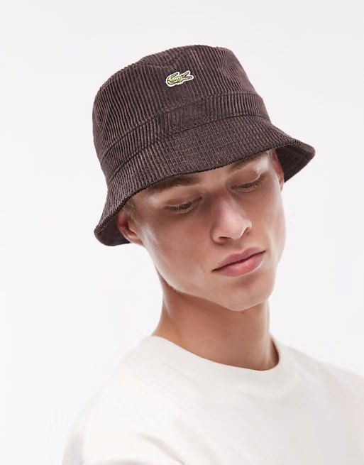 Lacoste Brown Corduroy Bucket Hat (Category: Caps & Hats) located in Polomolok. Submitted by marrssz (Listing ID 1470744276, Image 1). Description: - Brand: Lacoste - Material: Textured brown corduroy fabric - Design: Classic bucket hat with sloping brim and dark inner lining - Detail: Iconic embroidered crocodile logo patch on the front - Style: Perfect everyday streetwear accessory for casual outfits -MEDIUM TO LARGE HEAD.