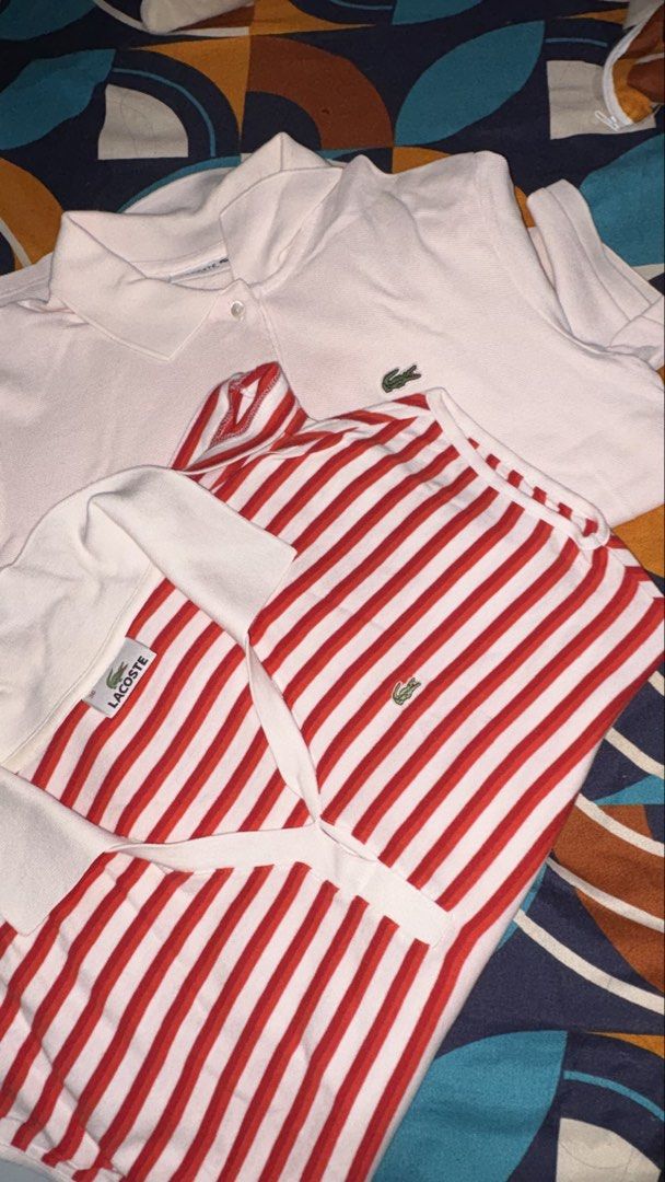 Lacoste Classic Fit Polo Shirts Bundle Size 36 (Category: Shirts) located in Munoz. Submitted by joanadelara (Listing ID 1470837634, Image 3). Description: - Set of 2 authentic Lacoste polo shirts in size 36 - Both include original branded neck tags - Shirt 1: Solid light pink, classic fit, button placket, embroidered chest crocodile - Shirt 2: Red and white stripes, v-neck collar design, crocodile logo on bottom hem - ₱800 for both.