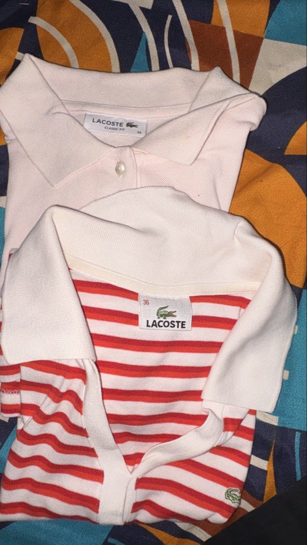 Lacoste Classic Fit Polo Shirts Bundle Size 36 (Category: Shirts) located in Munoz. Submitted by joanadelara (Listing ID 1470837634, Image 2). Description: - Set of 2 authentic Lacoste polo shirts in size 36 - Both include original branded neck tags - Shirt 1: Solid light pink, classic fit, button placket, embroidered chest crocodile - Shirt 2: Red and white stripes, v-neck collar design, crocodile logo on bottom hem - ₱800 for both.