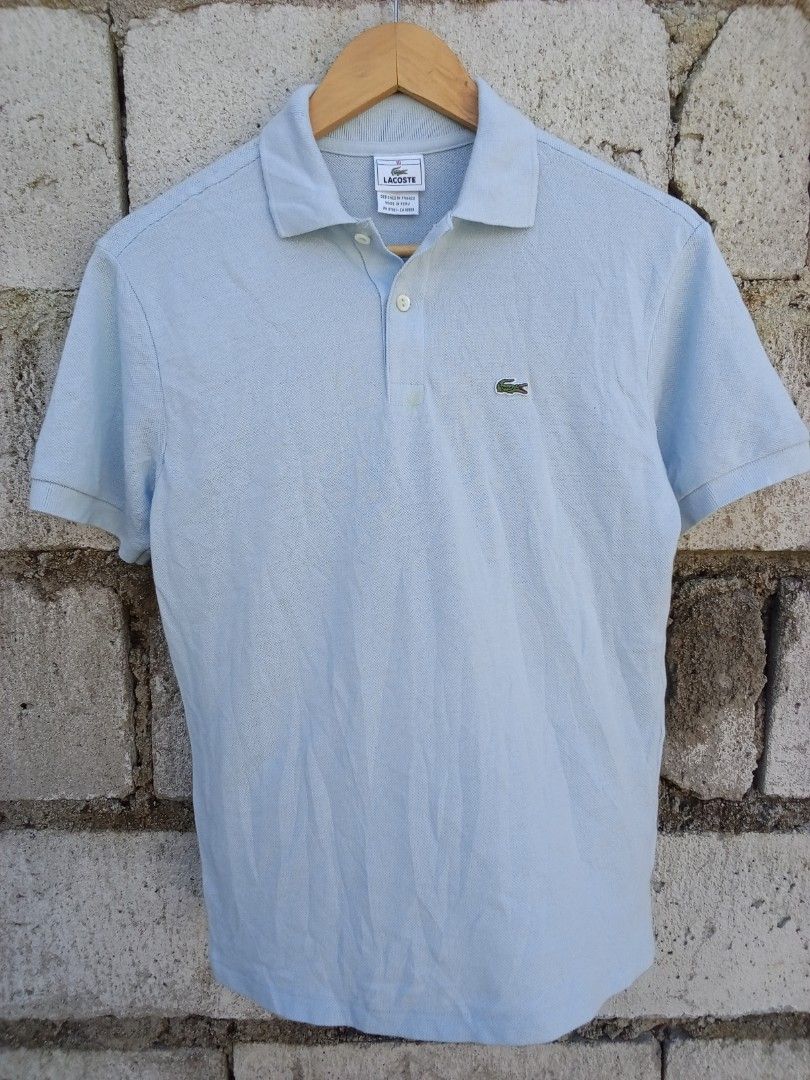 Lacoste Light Blue Polo Shirt (Category: Tshirts & Polo Shirts ) located in Dinalupihan. Submitted by yanyan.thirft (Listing ID 1470922159, Image 1). Description: - Brand: Lacoste - Color: Light blue - Material: Breathable cotton knit - Features: Short sleeves, two-button placket, ribbed collar and cuffs - Logo: Classic embroidered green crocodile on the chest - Fit: Standard fit - Condition: Great for casual days or smart-casual outings, easy to