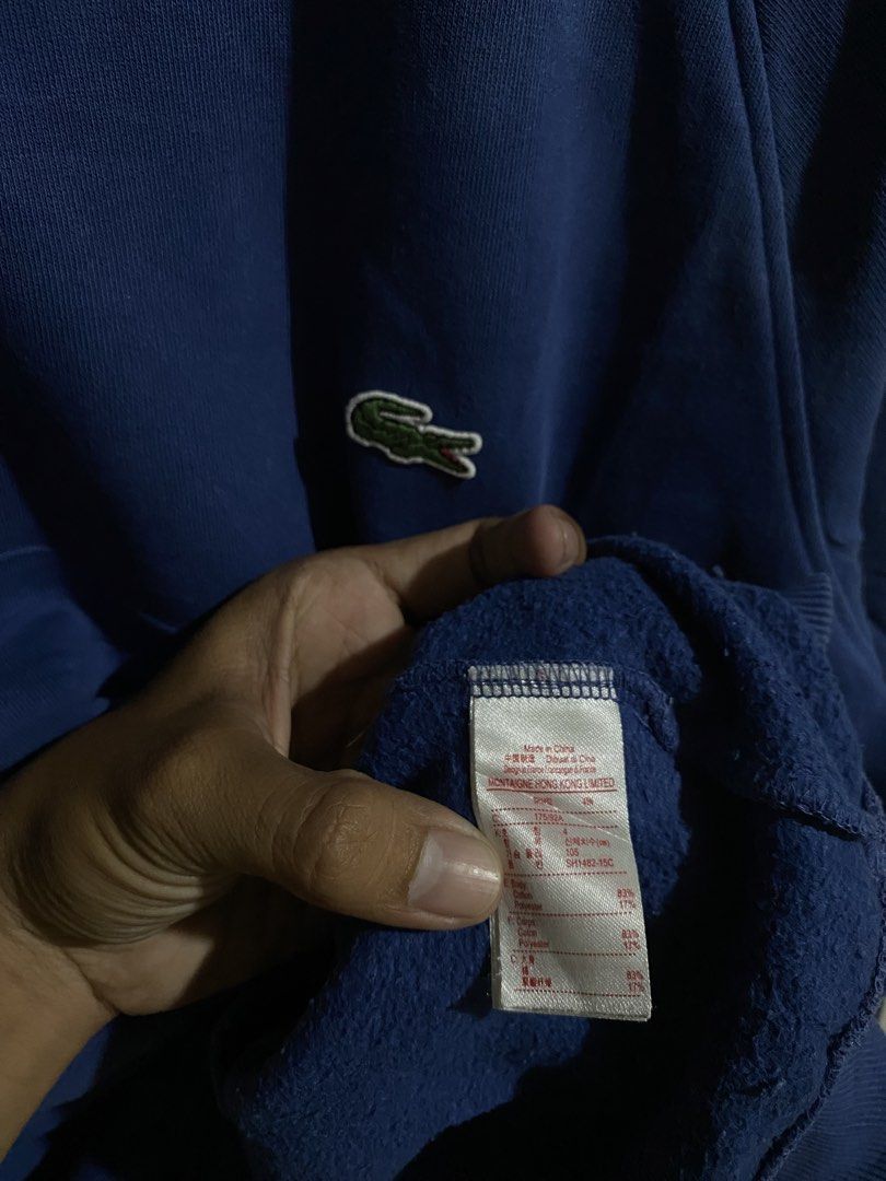 Lacoste Live Blue Sweatshirt Size 4 (Category: Coats, Jackets and Outerwear) located in Pandi. Submitted by nasya_thrift_collection2023 (Listing ID 1470858022, Image 3). Description: - Brand: Lacoste Live - Item: Crewneck Sweatshirt with side stripes - Color: Blue with dark blue contrast side stripes - Logo: Classic embroidered green crocodile on chest - Size: 4 (US Medium / 105) - Material: 83% cotton, 17% polyester blend - Details: Ribbed colla