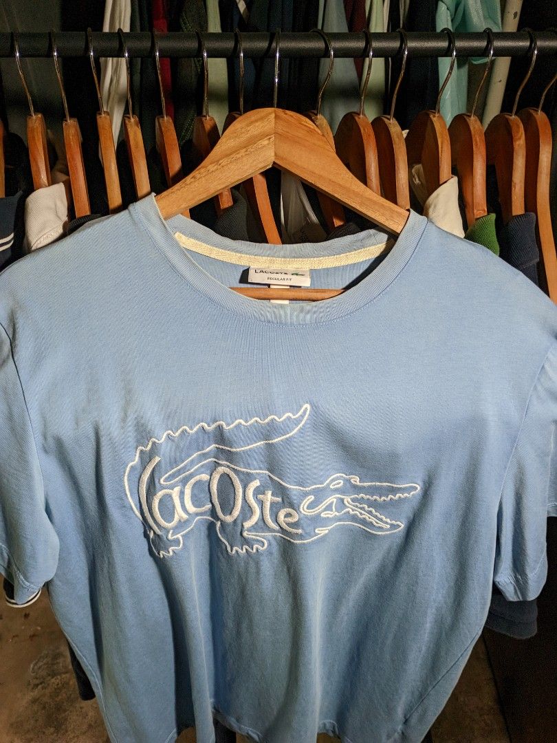 Lacoste Modern Embroidered Logo T-Shirt (Category: Tshirts & Polo Shirts ) located in Iriga City. Submitted by cxvgarments (Listing ID 1470783598, Image 2). Description: This piece is a contemporary graphic t-shirt from French heritage brand Lacoste, known for pioneering tennis sportswear since 1933. Unlike vintage Chemise Lacoste or Izod Lacoste production, this garment features modern internal satin care tags produced under Montaigne Hong Kong 