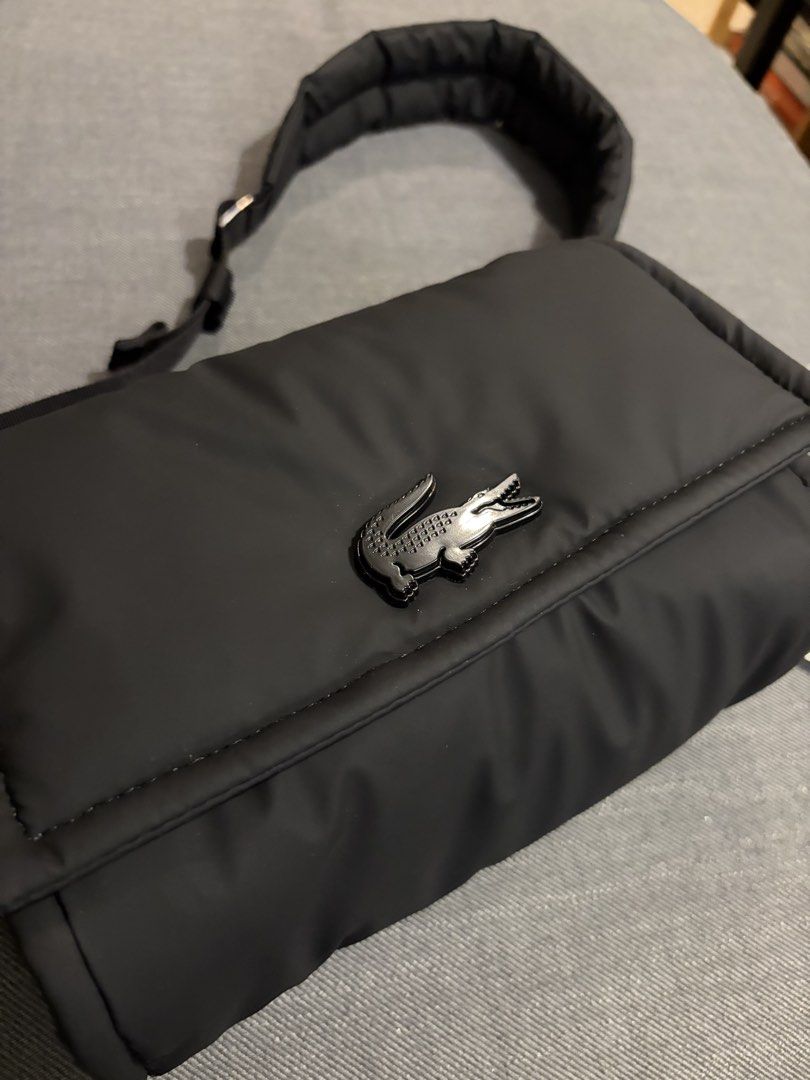 Lacoste Nylia Shoulder/Crossbody Bag (Category: Sling Bags) located in Paranaque City. Submitted by thebespoketraveler (Listing ID 1470916072, Image 3). Description: - Authentic Black Lacoste Nylia Shoulder/Crossbody bag (tag still attached) with paper bag and official receipt - Puffy quilted design with metal crocodile logo - Adjustable shoulder strap and comfortable padded - Shipping: Metro Manila.