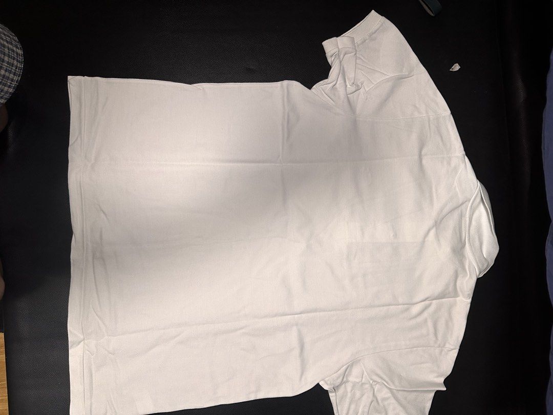 Lacoste White Polo Shirt Size Large (Category: Tshirts & Polo Shirts ) located in Las Pinas. Submitted by boldbear_89ab40 (Listing ID 1470827046, Image 3). Description: - Brand: Lacoste - Color: Clean White - Size: 4 - Material: 100% Cotton Knit - Origin: Designed in France, Made in Peru - Condition: Excellent/Worn with care - Features: Classic short sleeve, button placket, and collar - Styling: Versatile staple, easy to match with jeans or short