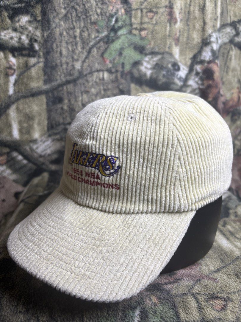 Lakers 1985 world Champion ship Hat (Category: Caps & Hats) located in Manila. Submitted by josh2295 (Listing ID 1470757382, Image 2). Description: cream/khaki corduroy dad hat featuring an embroidered Los Angeles Lakers logo and “1985 NBA World Champions” text by Mitchell & Ness..