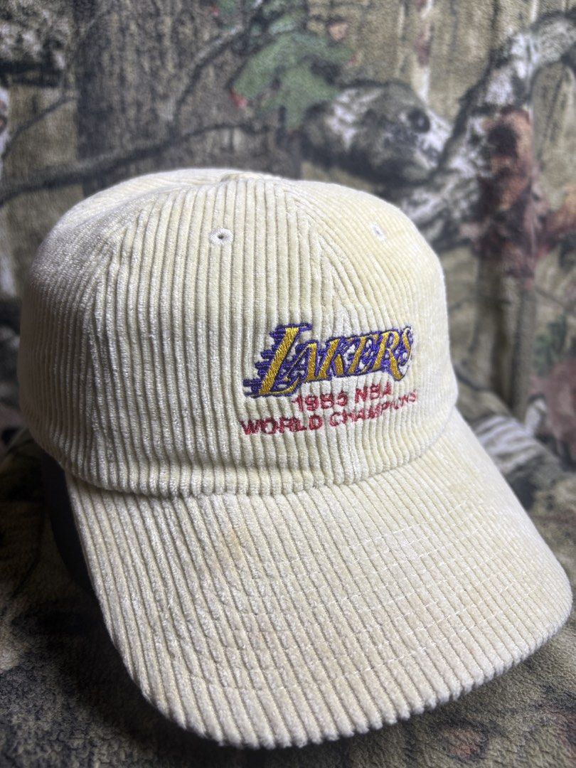Lakers 1985 world Champion ship Hat (Category: Caps & Hats) located in Manila. Submitted by josh2295 (Listing ID 1470757382, Image 1). Description: cream/khaki corduroy dad hat featuring an embroidered Los Angeles Lakers logo and “1985 NBA World Champions” text by Mitchell & Ness..