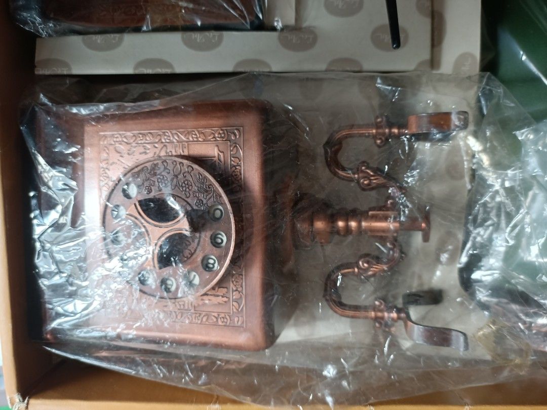 Le Art Telephone Rest Deluxe (Category: Massage Devices) located in Taguig. Submitted by grandfish_55ab5c (Listing ID 1470819020, Image 1). Description: - Brand: Le Art Telephone Rest Deluxe Set - Complete set includes: Bronze-finished rotary phone base design, matching pen, and decorative notepad holder - Design: Intricate vintage-style embossed patterns throughout - Packaging: Comes with original branded packaging box - Condition: Brand new / E