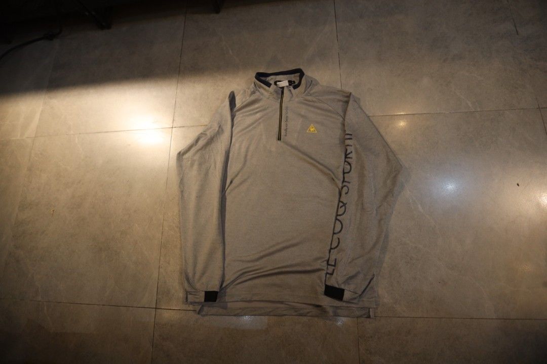 Le Coq Sportif Grey Quarter-Zip Long Sleeve Pullover (Category: Coats, Jackets and Outerwear) located in Manila. Submitted by krzxyprk (Listing ID 1470770731, Image 1). Description: - Brand: Le Coq Sportif - Style: Long sleeve quarter-zip pullover - Color: Grey with dark collar trim and yellow logo - Details: Brand lettering down the left sleeve - Material: Stretchy, breathable fabric (great for golf/activewear) - Fit: Standard men's cut, fits tr