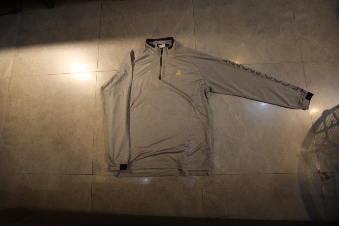 Le Coq Sportif Grey Quarter-Zip Long Sleeve Pullover (Category: Coats, Jackets and Outerwear) located in Manila. Submitted by krzxyprk (Listing ID 1470770731, Image 2). Description: - Brand: Le Coq Sportif - Style: Long sleeve quarter-zip pullover - Color: Grey with dark collar trim and yellow logo - Details: Brand lettering down the left sleeve - Material: Stretchy, breathable fabric (great for golf/activewear) - Fit: Standard men's cut, fits tr