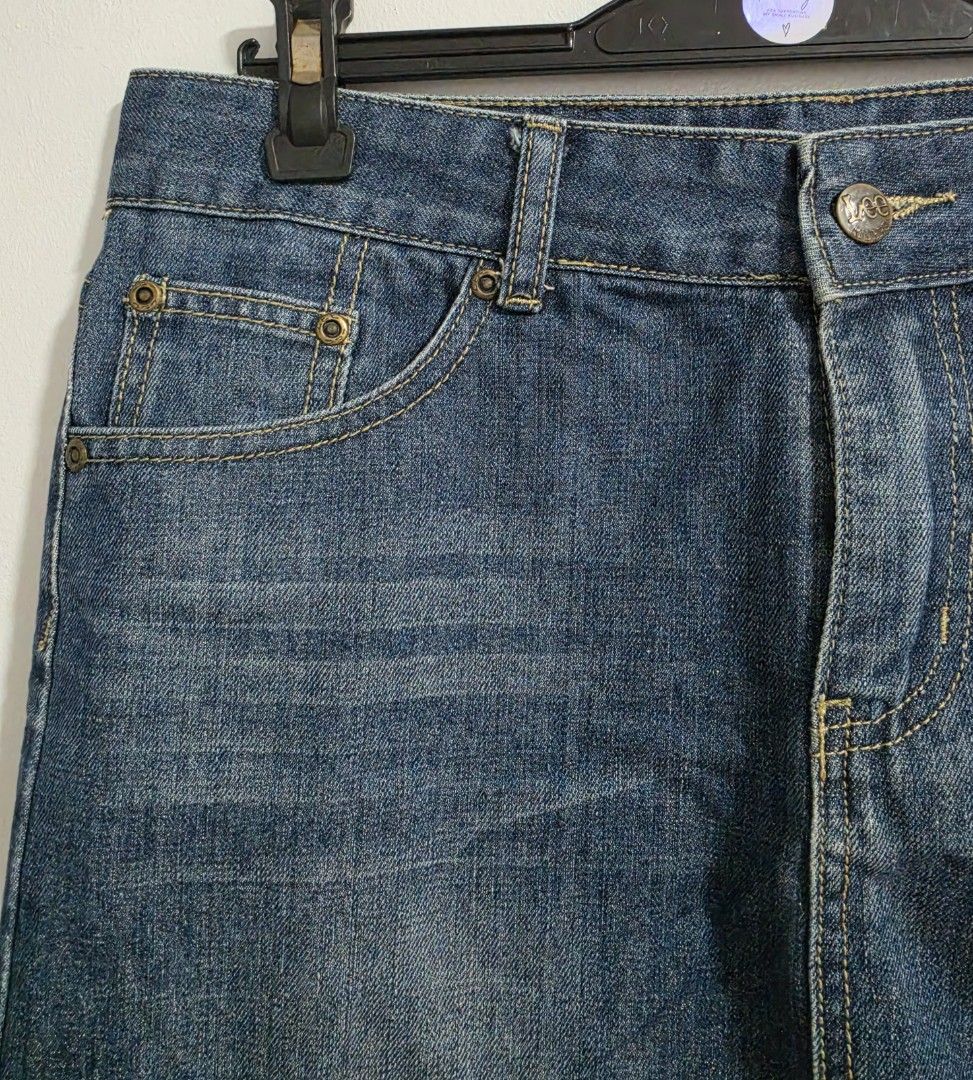 Lee Riders Denim Skirt (Category: Skirts) located in Paranaque City. Submitted by franinnashop (Listing ID 1470796806, Image 3). Description: Declutter - Brand: Lee Riders - Style: Classic blue denim skirt - Size: Waist 30", Hips 36", Length 14" - Closure: Front button with zipper fly - Pockets: Traditional 5-pocket styling plus coin pocket - Details: Contrast yellow stitching, branded metal hardware, and dark leather back patch - Material: Durab