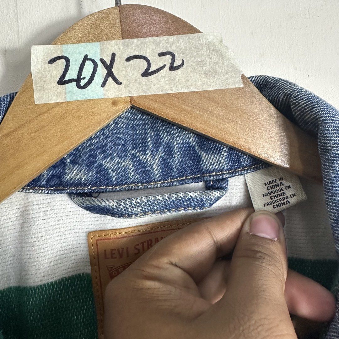 Levi Strauss & Co. Denim Jacket Size S (Category: Coats, Jackets and Outerwear) located in Manila. Submitted by direcmampu37948 (Listing ID 1470860696, Image 3). Description: - Brand: Levi's - Style: Classic denim jacket in a versatile blue wash - Size: Small (fits true to size) - Details: Unique contrast white and green lining inside the collar and back - Pockets: Convenient front button chest pockets and side pockets - Material: Durable cotton 