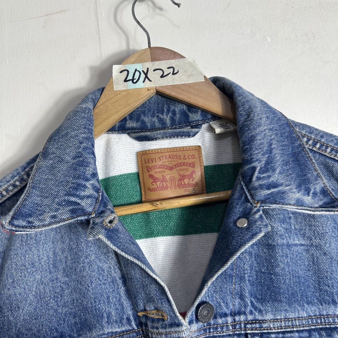 Levi Strauss & Co. Denim Jacket Size S (Category: Coats, Jackets and Outerwear) located in Manila. Submitted by direcmampu37948 (Listing ID 1470860696, Image 2). Description: - Brand: Levi's - Style: Classic denim jacket in a versatile blue wash - Size: Small (fits true to size) - Details: Unique contrast white and green lining inside the collar and back - Pockets: Convenient front button chest pockets and side pockets - Material: Durable cotton 