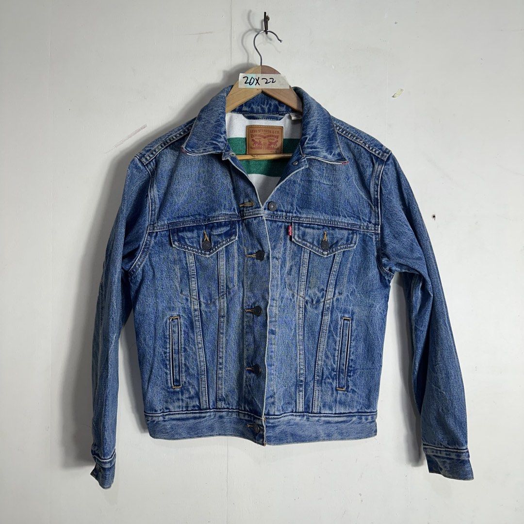 Levi Strauss & Co. Denim Jacket Size S (Category: Coats, Jackets and Outerwear) located in Manila. Submitted by direcmampu37948 (Listing ID 1470860696, Image 1). Description: - Brand: Levi's - Style: Classic denim jacket in a versatile blue wash - Size: Small (fits true to size) - Details: Unique contrast white and green lining inside the collar and back - Pockets: Convenient front button chest pockets and side pockets - Material: Durable cotton 