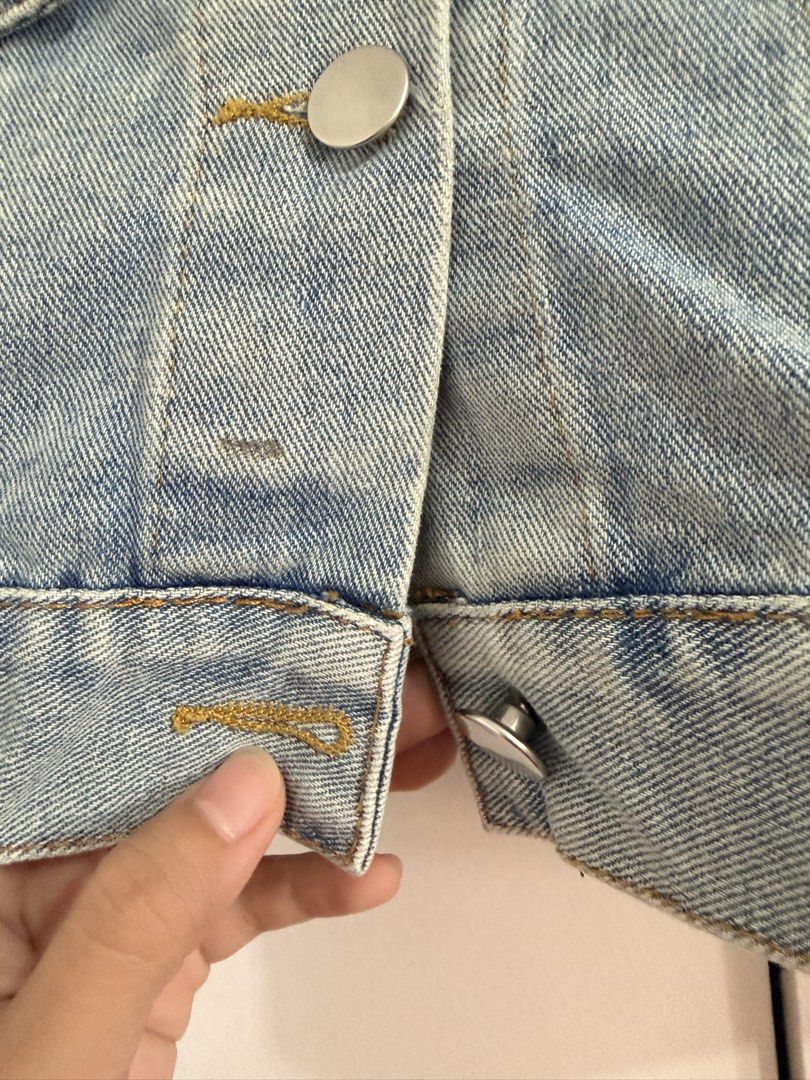 Light Blue Cropped Denim Jacket (Category: Coats, Jackets and Outerwear) located in Marikina City. Submitted by _bananahanaa (Listing ID 1470768217, Image 3). Description: - Color: Light blue wash - Fit: Trendy cropped cut - Details: Classic collar, front button closure, two chest flap pockets, metal hardware - Style: Versatile layering piece that matches any outfit.