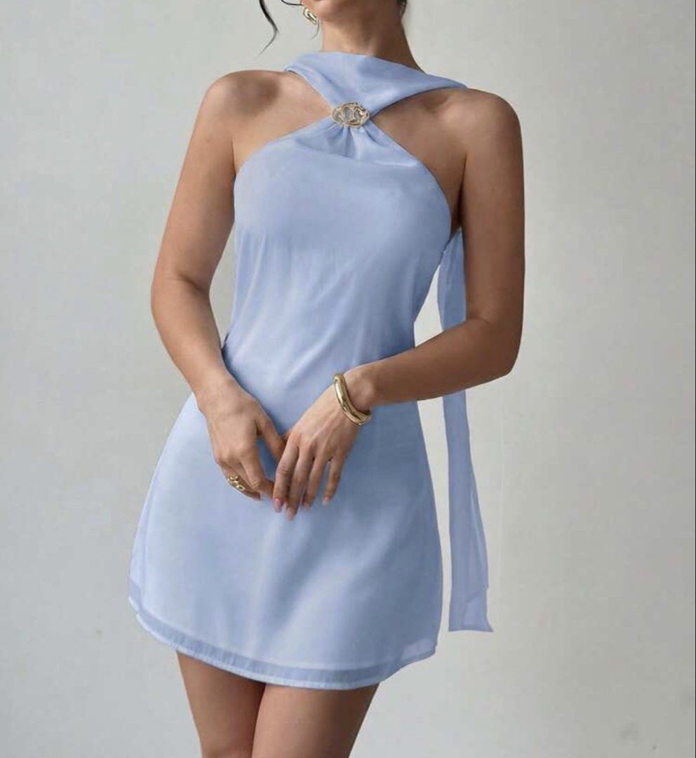 Light blue Halter mini dress (Category: Dresses) located in Manila. Submitted by clnanxiee (Listing ID 1470910240, Image 1). Description: - Color: Light blue with a slight sheen - Style: Halter mini dress, sleeveless with a high neckline and back tie strap - Detail: Chic gold-tone decorative buckle at the front collar - Condition: Worn once for a quick photo shoot, basically untouched - Fit: Best fits small to medium frames.