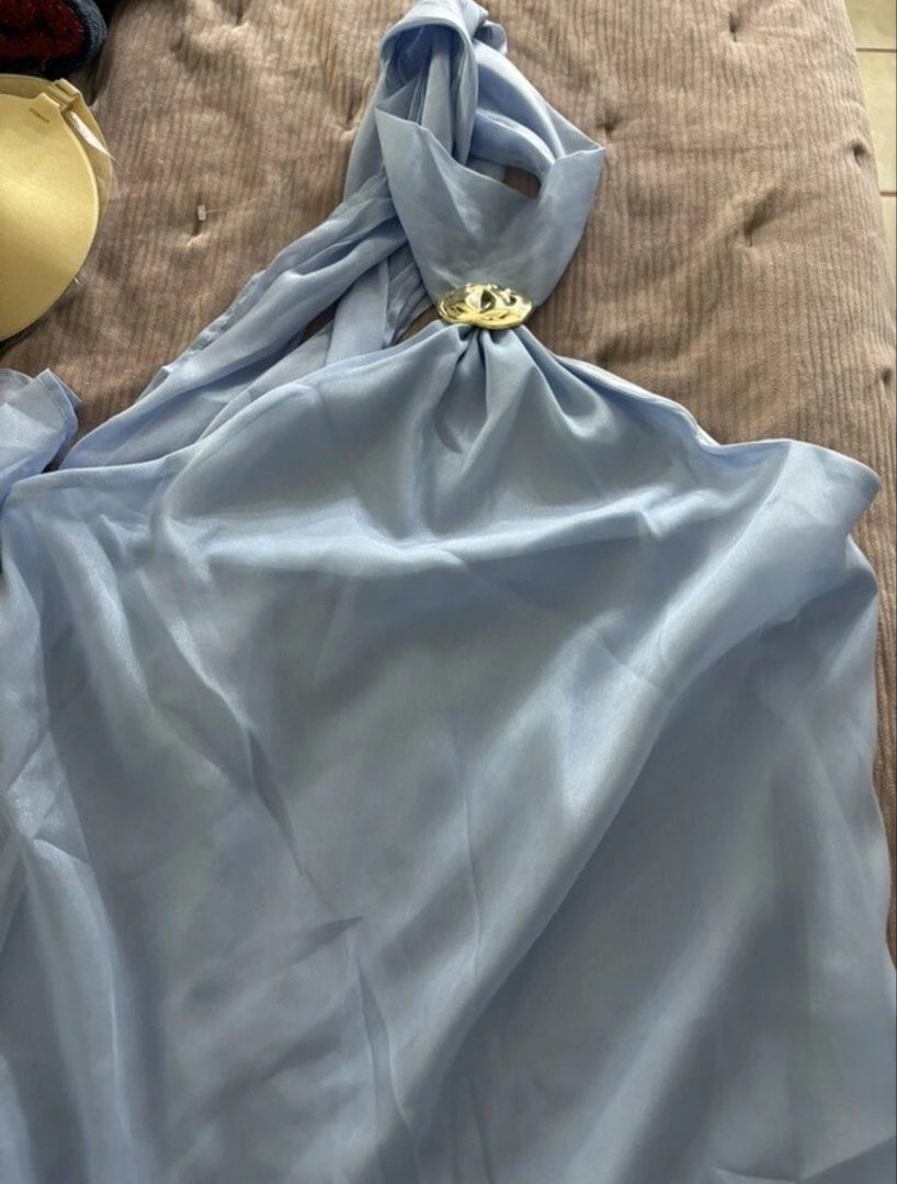 Light blue Halter mini dress (Category: Dresses) located in Manila. Submitted by clnanxiee (Listing ID 1470910240, Image 2). Description: - Color: Light blue with a slight sheen - Style: Halter mini dress, sleeveless with a high neckline and back tie strap - Detail: Chic gold-tone decorative buckle at the front collar - Condition: Worn once for a quick photo shoot, basically untouched - Fit: Best fits small to medium frames.