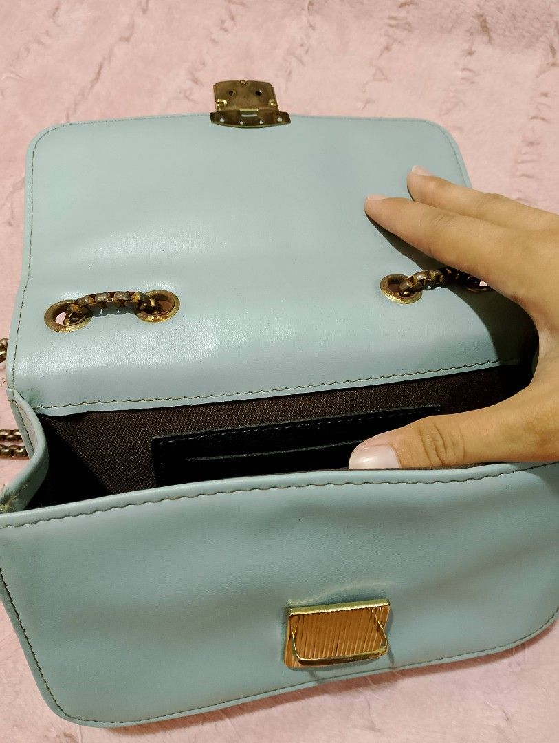 Light Blue Quilted Crossbody/Shoulder Bag with Chain Strap (Category: Shoulder Bags) located in Quezon City. Submitted by ivriory.wolfie (Listing ID 1470869081, Image 3). Description: Color: Pastel blue with dark brown interior lining Design: Quilted panel detail on the flap with secure lock closure and antique finish link chain strap Interior: Features a handy slip pocket for small essentials Condition: Clean and well-maintained all around .