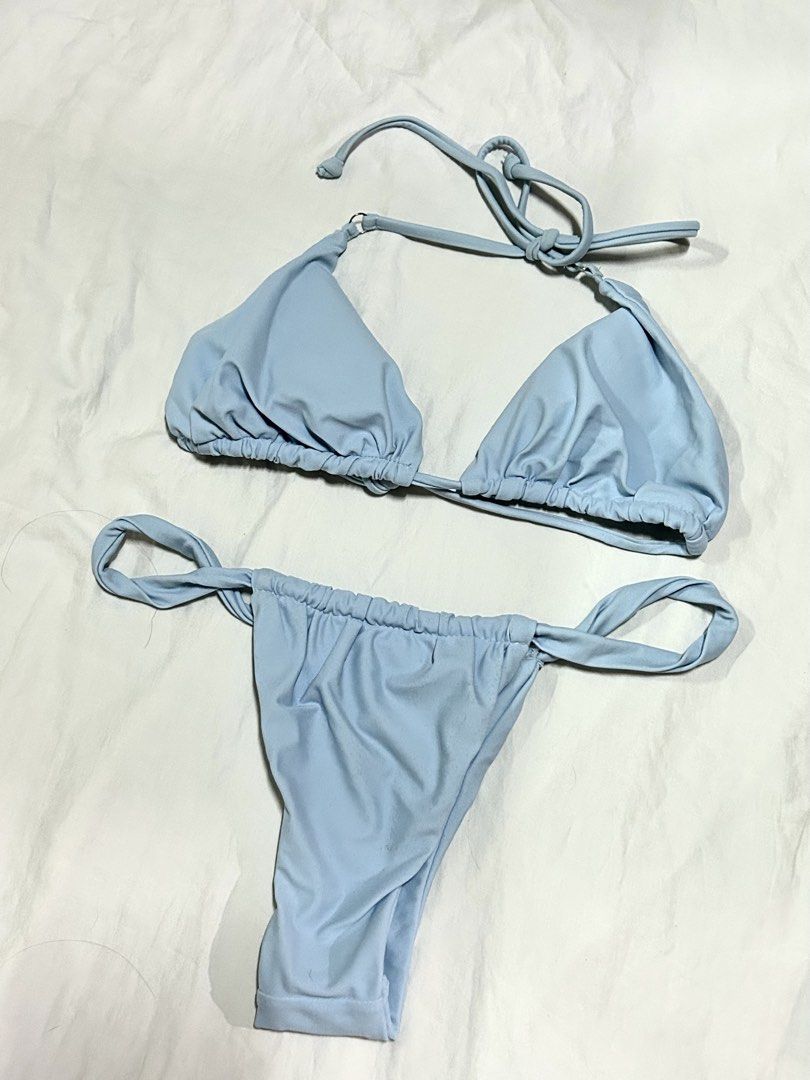 Light Blue Two-Piece Bikini Set (Category: Bikinis & Swimsuits) located in Muntinlupa City. Submitted by _gudstuff (Listing ID 1470828558, Image 2). Description: - Color: Light blue - Style: Two-piece bikini set with simple solid color - Top: Triangle cut with adjustable halter ties and gathered under-bust band - Bottoms: Adjustable side ties with gathered waist detailing - Material: Soft and stretchy fabric - Good as new.