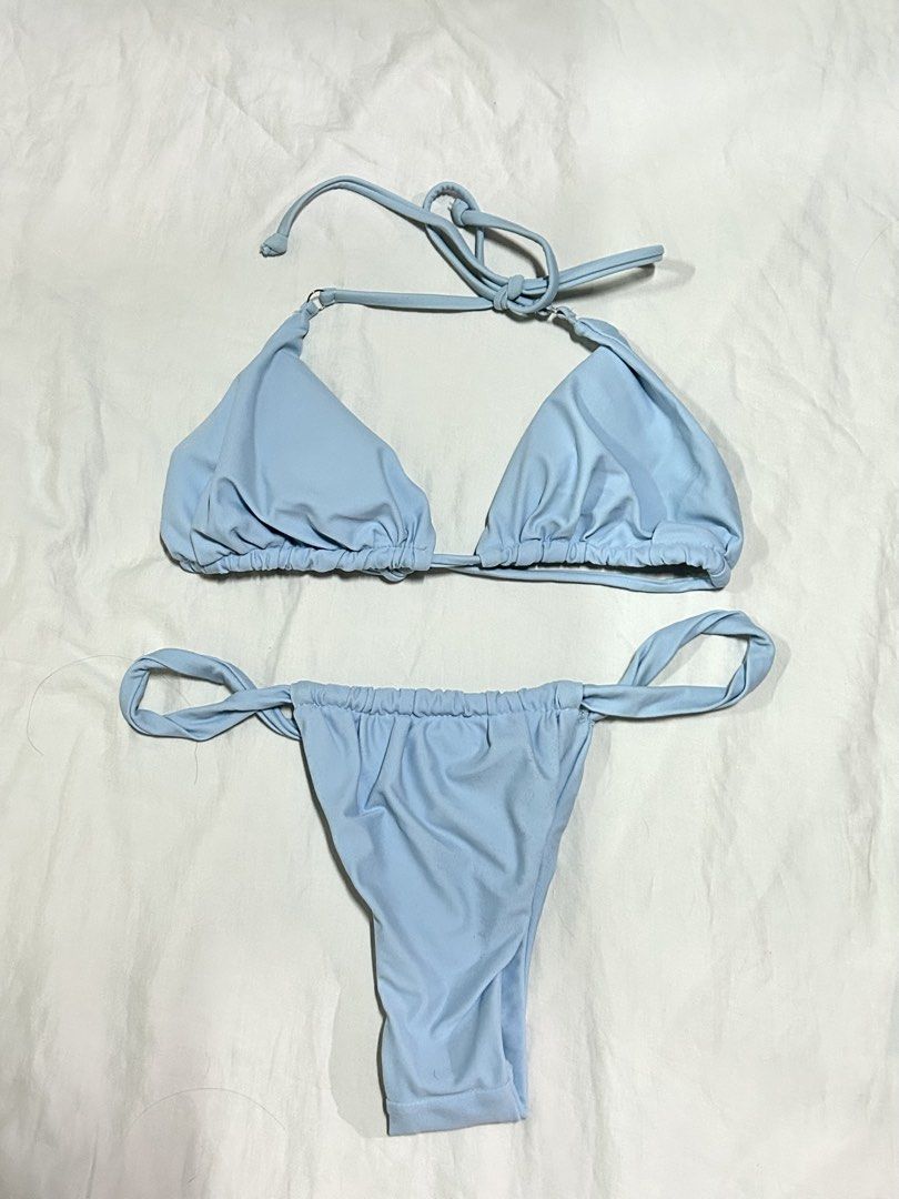 Light Blue Two-Piece Bikini Set (Category: Bikinis & Swimsuits) located in Muntinlupa City. Submitted by _gudstuff (Listing ID 1470828558, Image 1). Description: - Color: Light blue - Style: Two-piece bikini set with simple solid color - Top: Triangle cut with adjustable halter ties and gathered under-bust band - Bottoms: Adjustable side ties with gathered waist detailing - Material: Soft and stretchy fabric - Good as new.