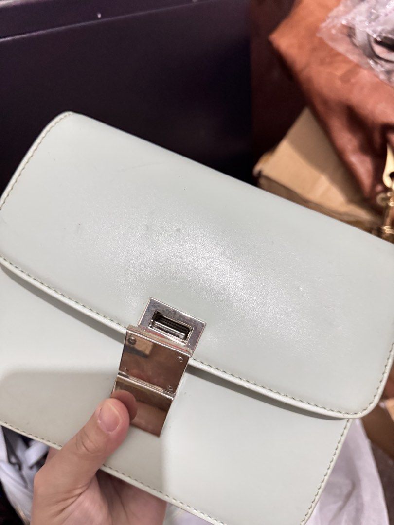 Light green structured leather crossbody bag with silver hardware (Category: Cross-body Bags) located in Manila. Submitted by dearpinkcollections (Listing ID 1470849831, Image 3). Description: - Color: Light green - Style: Structured, boxy shoulder bag with front flap closure - Hardware: Metallic silver push-lock clasp and strap rings - Material: Smooth leather finish - Strap: Matching adjustable shoulder strap - Condition: Minor scuffs and marks