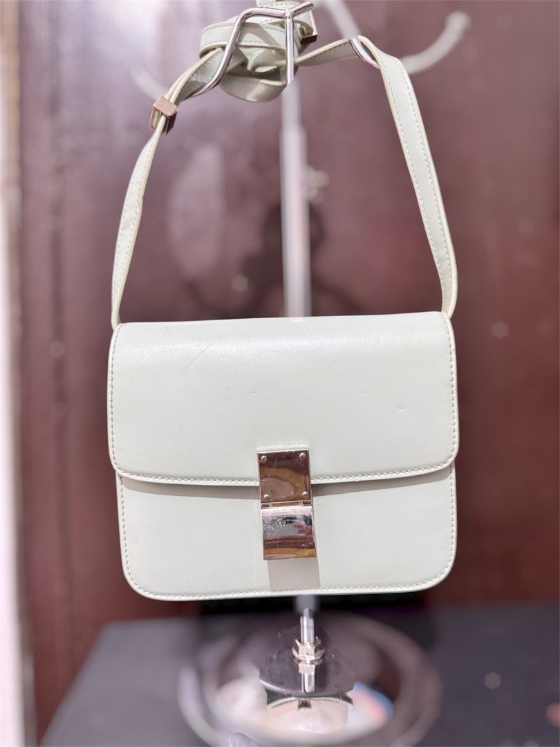 Light green structured leather crossbody bag with silver hardware (Category: Cross-body Bags) located in Manila. Submitted by dearpinkcollections (Listing ID 1470849831, Image 1). Description: - Color: Light green - Style: Structured, boxy shoulder bag with front flap closure - Hardware: Metallic silver push-lock clasp and strap rings - Material: Smooth leather finish - Strap: Matching adjustable shoulder strap - Condition: Minor scuffs and marks