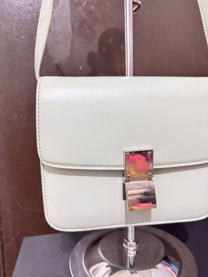 Light green structured leather crossbody bag with silver hardware (Category: Cross-body Bags) located in Manila. Submitted by dearpinkcollections (Listing ID 1470849831, Image 2). Description: - Color: Light green - Style: Structured, boxy shoulder bag with front flap closure - Hardware: Metallic silver push-lock clasp and strap rings - Material: Smooth leather finish - Strap: Matching adjustable shoulder strap - Condition: Minor scuffs and marks