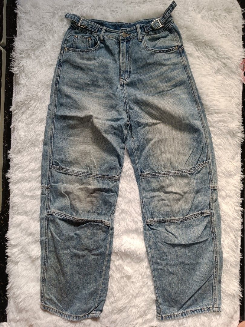 Light wash baggy denim jeans with panel details (Category: Jeans) located in Orani. Submitted by mbfb_btn (Listing ID 1470823328, Image 1). Description: - Style: Casual streetwear light wash denim jeans with a relaxed baggy fit - Size 32 - Details: Heavy distressing, fading, and unique knee panel construction - Features: Adjustable built-in belt loops with stylish silver metal hardware - Fit: Straight wide-leg cut with a single back pocket - Cond