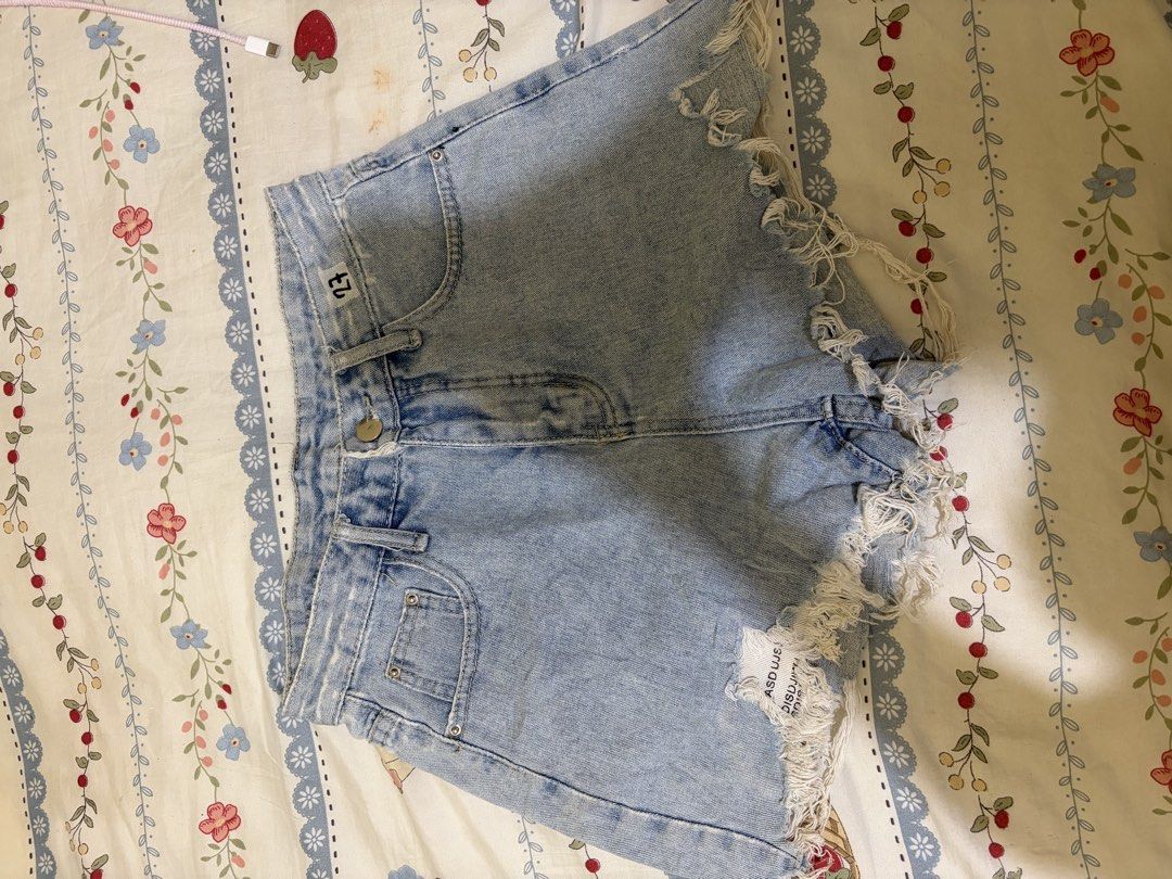 Light wash denim cut-off shorts size 27 (Category: Shorts) located in Taguig. Submitted by rarebird_84db64 (Listing ID 1470817816, Image 1). Description: - Size: 27 - Wash: Light denim - Style: High-waisted with front button closure and belt loops - Details: Heavy frayed hems and trendy distressing on the right leg - Pockets: Functional front pockets - Condition: Great casual piece, easy to pair with any basic top.
