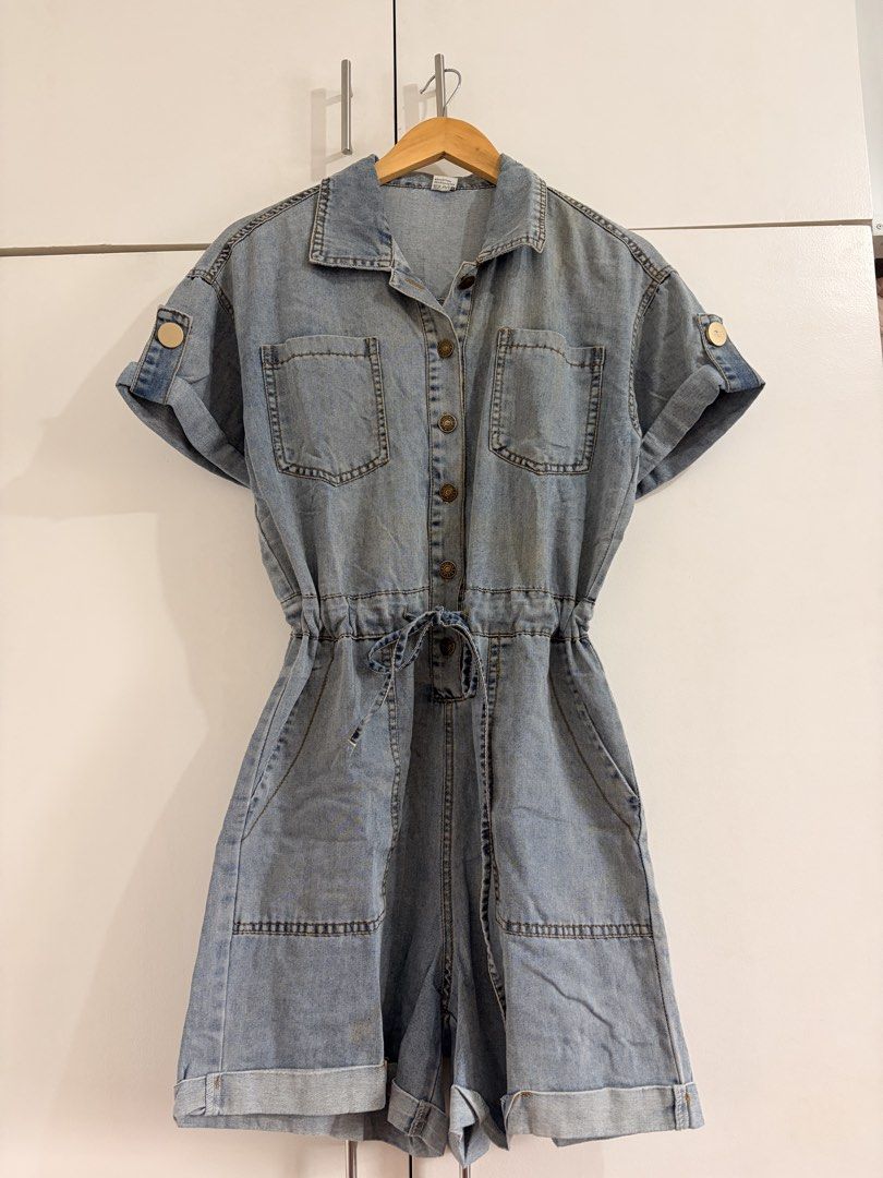 Light wash denim short jumpsuit romper size M (Category: Rompers) located in Marikina City. Submitted by _bananahanaa (Listing ID 1470800832, Image 1). Description: - Size: Medium - Wash: Light denim - Details: Button-up front, collar, cuffed short sleeves, and folded shorts cuffs - Fit: Adjustable drawstring tie at the waist - Pockets: Two chest pockets and two front side pockets - Style: Easy casual wear, perfect for everyday outifts - fits med