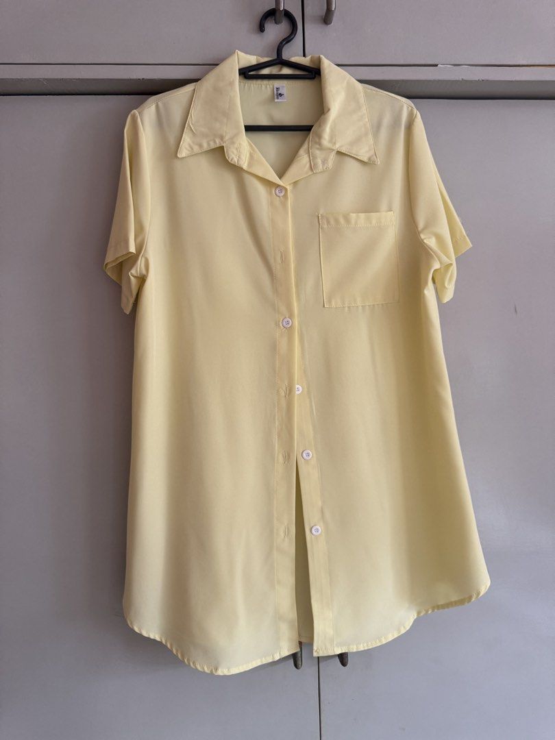 Light Yellow Short Sleeve Button Up Shirt (Category: Blouses) located in Taytay. Submitted by darkswan016 (Listing ID 1470830270, Image 1). Description: - Color: Light yellow - Style: Short-sleeve button-down with collar - Details: Single left chest pocket, curved hemline - Fit: Relaxed, lightweight fabric - Versatility: Easy to pair with jeans or slacks, great for warm weather.