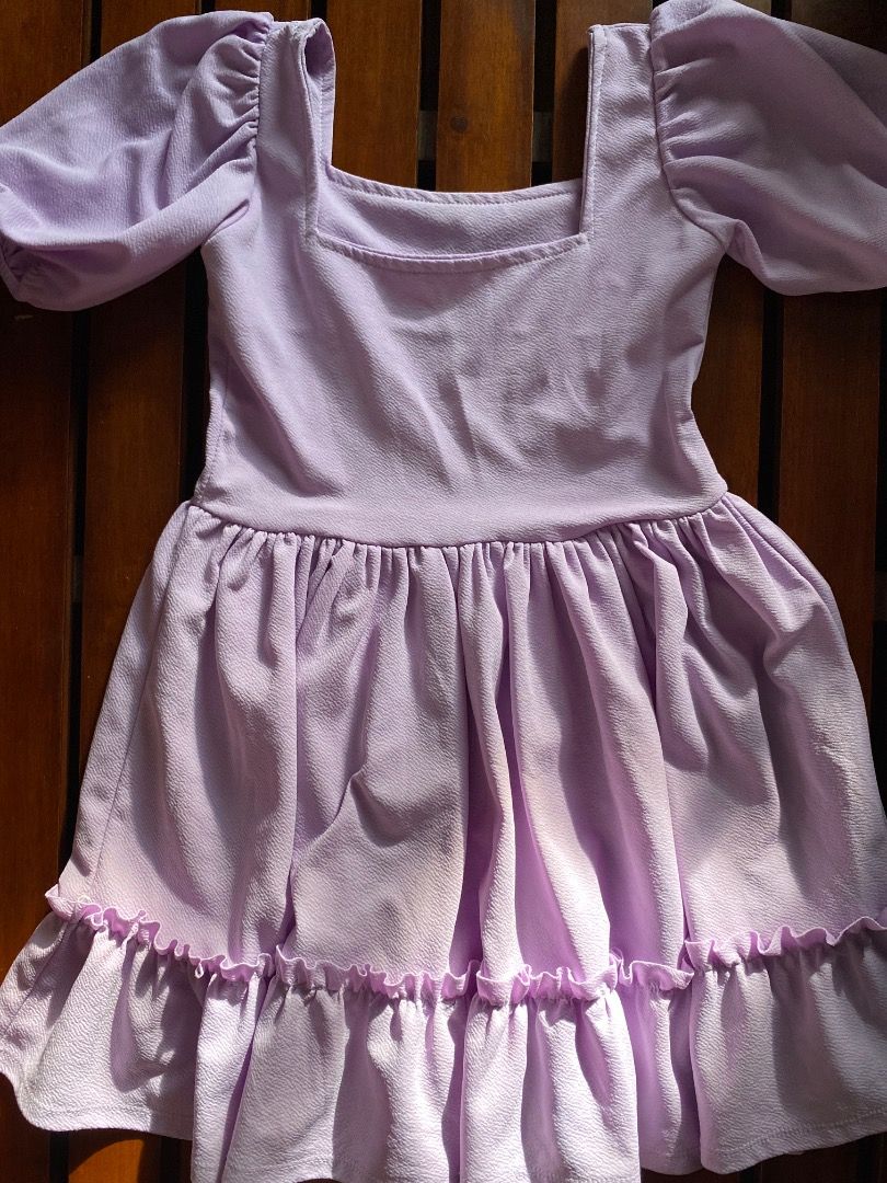 Lilac Square Neck Ruffle Dress (Category: Dresses) located in Pateros City. Submitted by strawberhyun (Listing ID 1470815528, Image 1). Description: - Color: Lilac - Style: Mini dress with fitted bodice and flared skirt - Details: Short puff sleeves, square neckline, and bottom ruffle tier - Fabric: Textured and comfortable - Perfect for: Casual days out and casual dates - Small to Medium.
