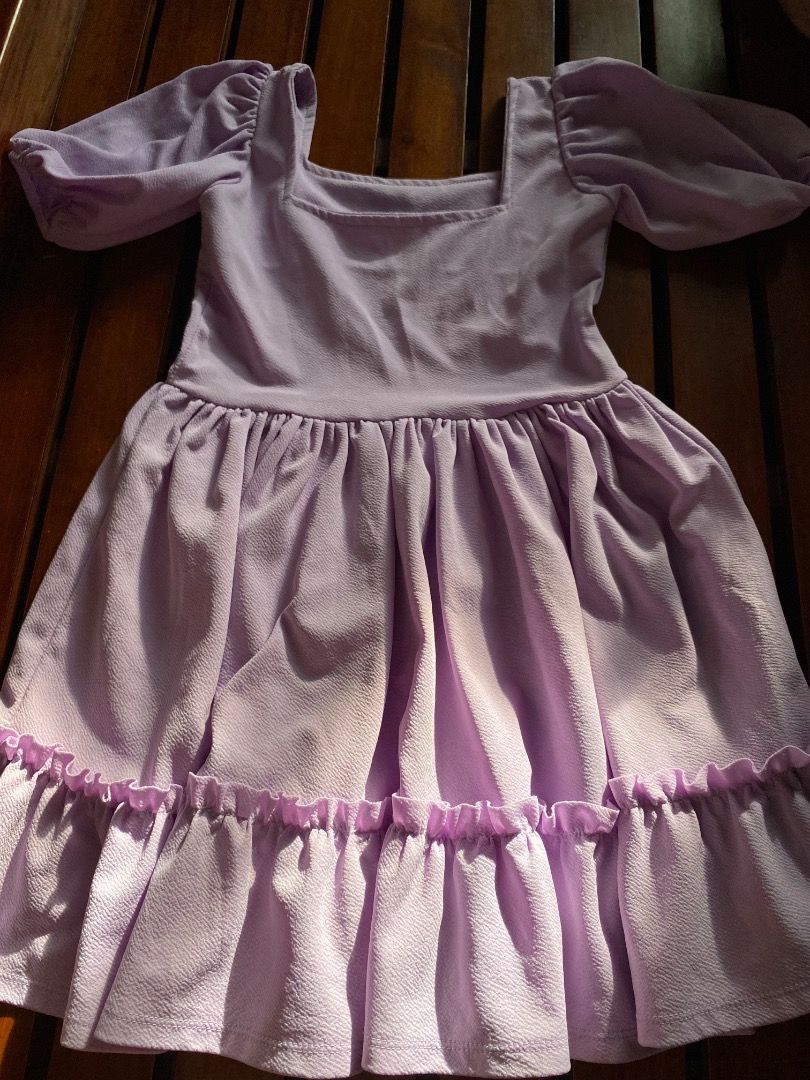 Lilac Square Neck Ruffle Dress (Category: Dresses) located in Pateros City. Submitted by strawberhyun (Listing ID 1470815528, Image 3). Description: - Color: Lilac - Style: Mini dress with fitted bodice and flared skirt - Details: Short puff sleeves, square neckline, and bottom ruffle tier - Fabric: Textured and comfortable - Perfect for: Casual days out and casual dates - Small to Medium.