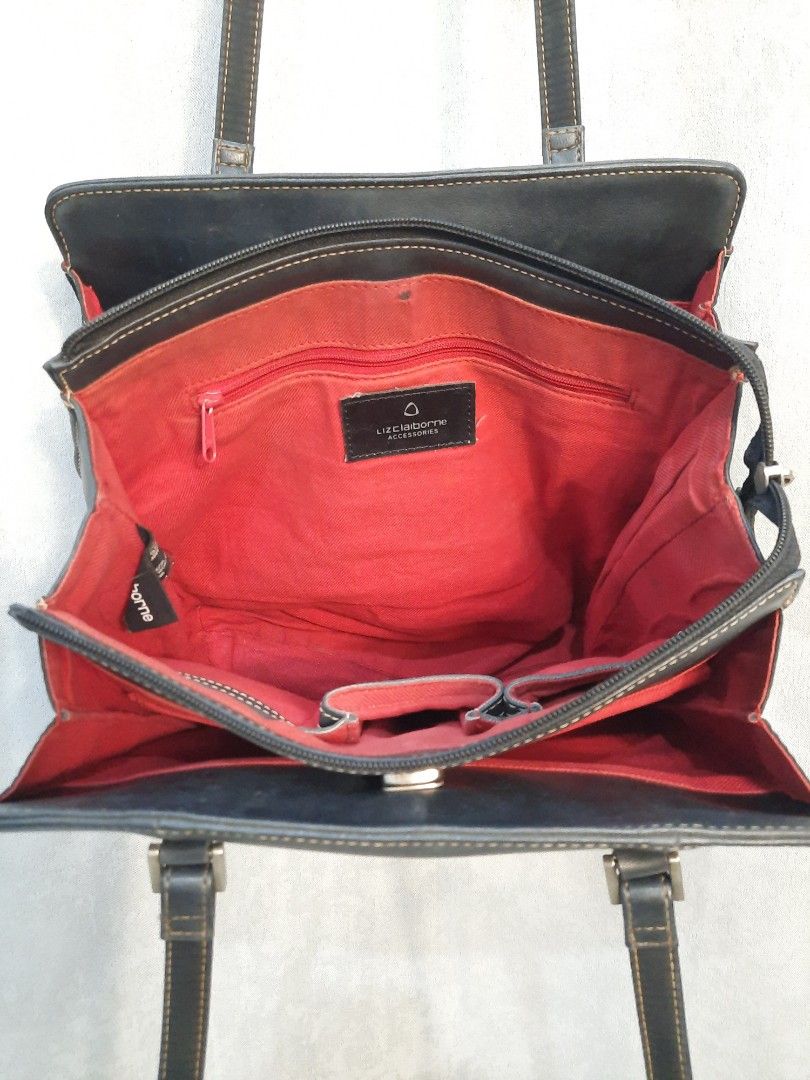 Liz Claiborne Black Leather Shoulder Bag (Category: Shoulder Bags) located in Marilao. Submitted by mariealeiah (Listing ID 1470752223, Image 2). Description: - Brand: Liz Claiborne - Color: Classic black exterior with a vibrant red fabric interior - Material: Premium leather with stylish contrast stitching - Straps: Comfortable long dual straps - Hardware: Sleek silver-tone accents - Storage: Structured rectangular shape with multiple internal c