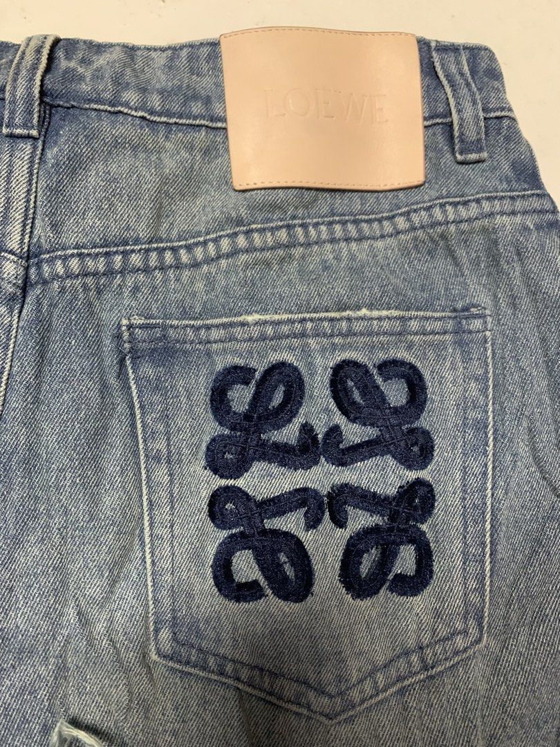 Loewe Anagram Denim Shorts Size 38 (Category: Luxury Apparel) located in Iloilo. Submitted by johnpullan30303 (Listing ID 1470833448, Image 2). Description: - Brand: Loewe - Item: Denim shorts in light wash - Size: 38 - Material: 100% cotton (Made in Italy) - Details: Iconic Anagram logo embroidered on the back pocket - Hem: Raw frayed hems with pocket lining visible underneath - Branding: Tan leather patch with embossed Loewe logo at the back wa