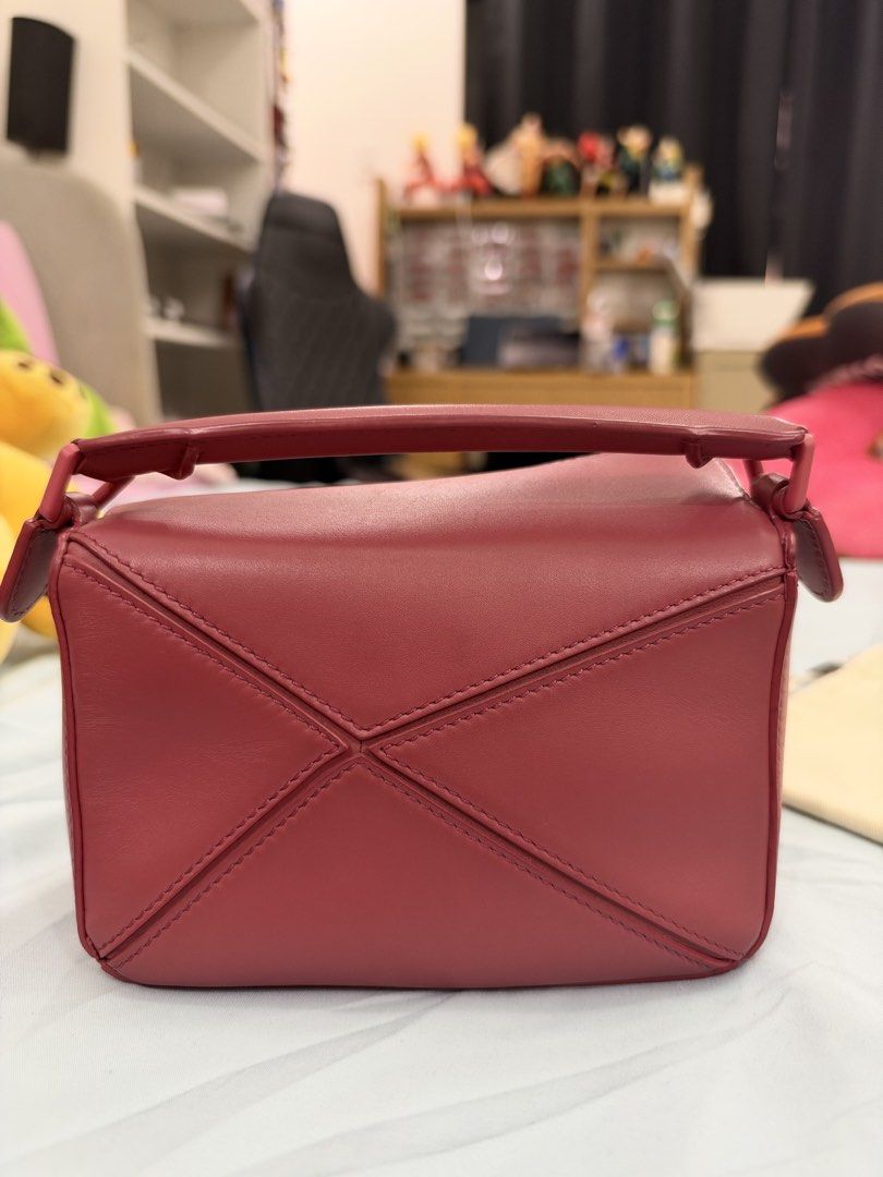 Loewe Mini Puzzle Bag (Category: Luxury Bags & Wallets) located in Bulacan. Submitted by rich3lle (Listing ID 1470832373, Image 3). Description: - Authentic Loewe Puzzle bag in stunning pink leather - Iconic geometric panel design with top handle and removable shoulder strap - Pristine condition with hardware still wrapped or untouched - Perfect structured everyday luxury bag - Comes complete with original Loewe storage box, dust bag, and product