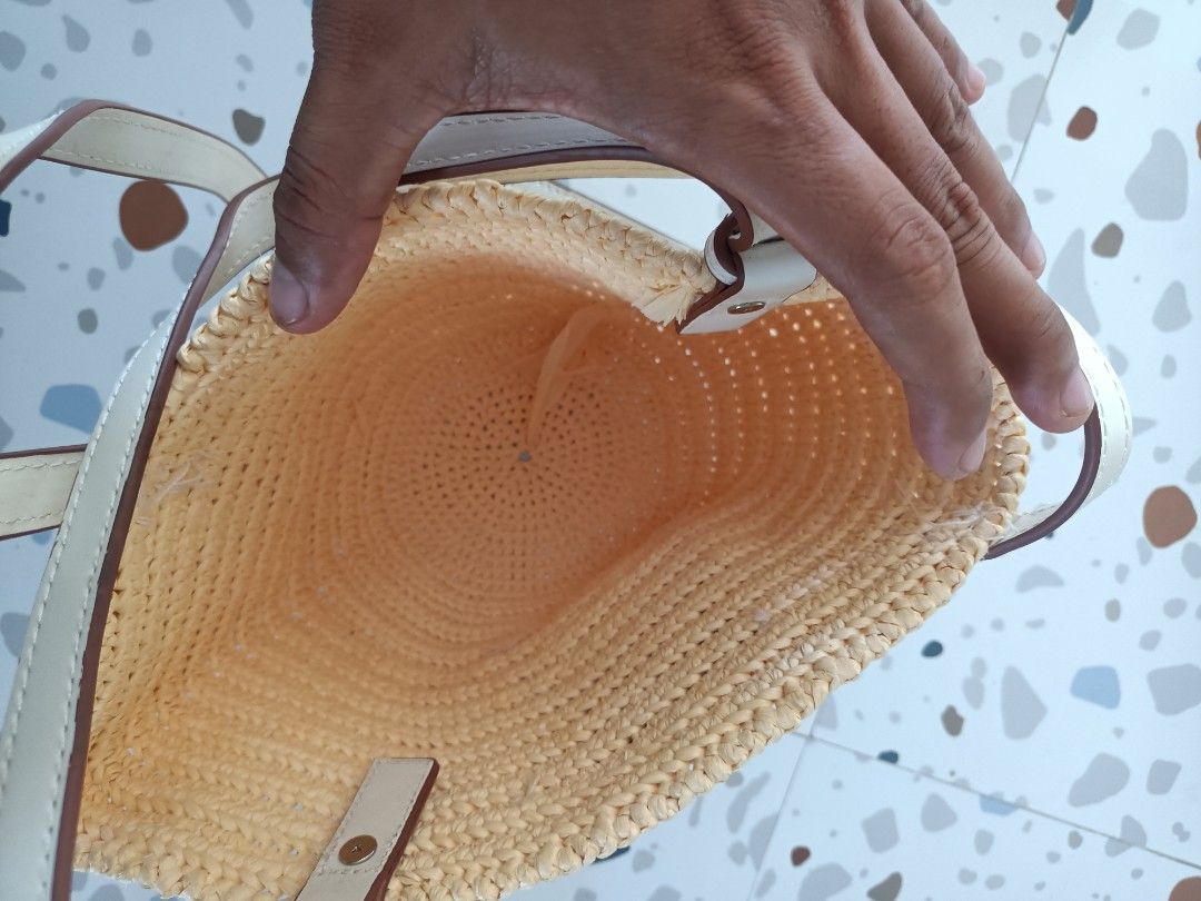 Loewe Raffia Basket Shoulder Bag Cream Leather (Category: Shoulder Bags) located in Zamboanga. Submitted by caps_luck (Listing ID 1470744666, Image 2). Description: - Authentic Loewe woven basket bag in natural straw - Double white leather straps with adjustable buckle detail - Cream front leather patch featuring the classic Anagram logo - Open top design with a spacious, unlined interior - Lightweight style ideal for beach days and warm weather 