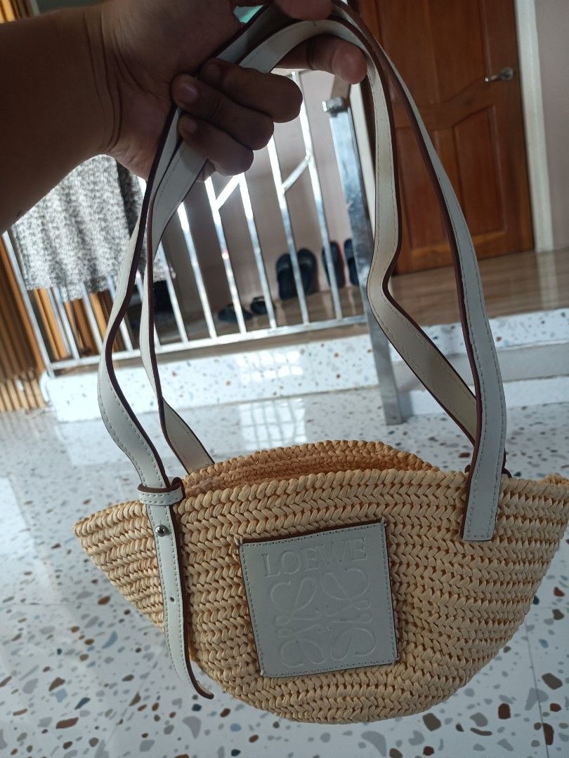 Loewe Raffia Basket Shoulder Bag Cream Leather (Category: Shoulder Bags) located in Zamboanga. Submitted by caps_luck (Listing ID 1470744666, Image 3). Description: - Authentic Loewe woven basket bag in natural straw - Double white leather straps with adjustable buckle detail - Cream front leather patch featuring the classic Anagram logo - Open top design with a spacious, unlined interior - Lightweight style ideal for beach days and warm weather 