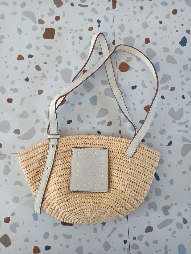 Loewe Raffia Basket Shoulder Bag Cream Leather (Category: Shoulder Bags) located in Zamboanga. Submitted by caps_luck (Listing ID 1470744666, Image 1). Description: - Authentic Loewe woven basket bag in natural straw - Double white leather straps with adjustable buckle detail - Cream front leather patch featuring the classic Anagram logo - Open top design with a spacious, unlined interior - Lightweight style ideal for beach days and warm weather 