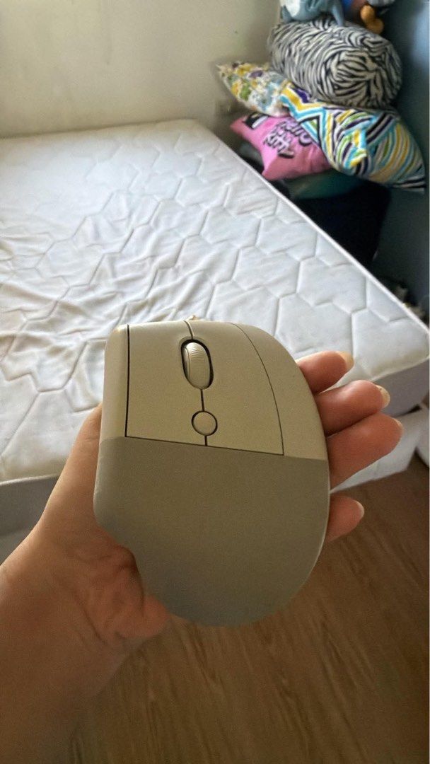 Logitech Lift Vertical Ergonomic Mouse Off-White (Category: Mouse & Mousepads) located in Manila. Submitted by kang_cl0ud33 (Listing ID 1470747646, Image 2). Description: - Model: Logitech Lift Vertical Ergonomic Mouse - Color: Cream/beige - Condition: Fully functional with a clean grip texture - Ergonomics: Natural handshake position to reduce wrist strain during long hours - Features: Two side thumb buttons, smooth scroll wheel, and top DPI swi