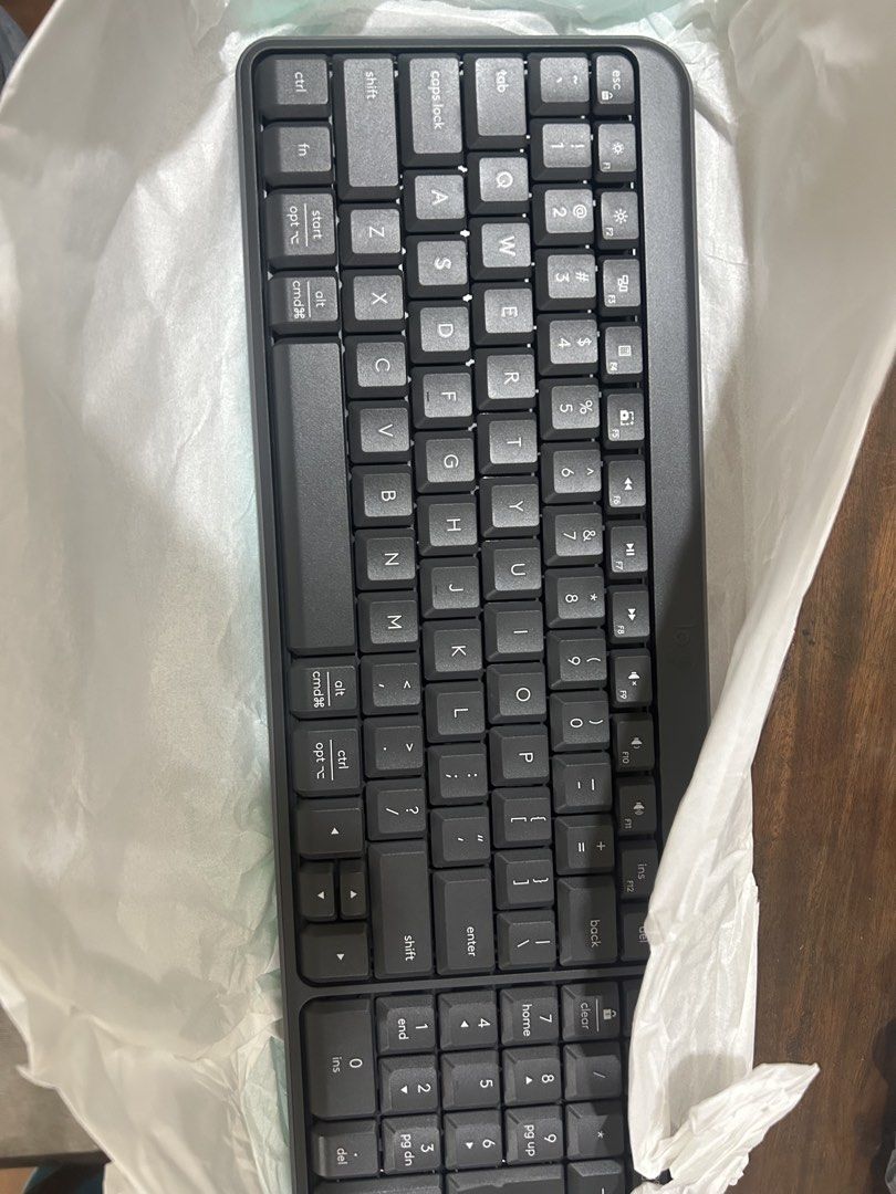 Logitech MK250 KEYBOARD ONLY (Category: Computer Keyboard) located in Manila. Submitted by cardoodoo (Listing ID 1470860009, Image 2). Description: - Model: Logitech MK250 keyboard - Color: Dark grey finish - Condition: Unwrapped unit inside protective paper wrapping - Packaging: Includes original teal box - Features: Wireless setup, ready for desk use.