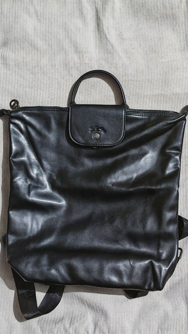 Longchamp Black Leather Backpack (Category: Luxury Bags & Wallets) located in Quezon City. Submitted by sureandlegit (Listing ID 1470902722, Image 1). Description: For Sale Longchamp Extra M Full Leather Backpack Noir color With 1 zip pocket and 1 open pocket inside. Can fit 13 - 15inch laptop Made in Tunisia Slightly used, good as brand new Bought from Japan 2nd hand shop Bought for 7,500 after tax refund Bag only Can provide LC ziplock packagin