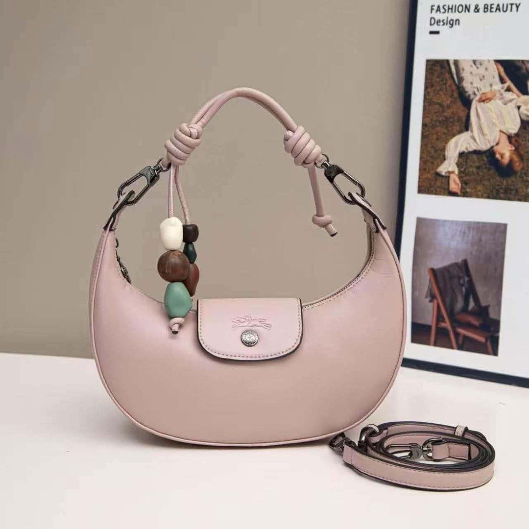 ✨Longchamp Crescent Moon Leather Bag with Bead Charm (Category: Luxury Bags & Wallets) located in Batangas. Submitted by shairapretty (Listing ID 1470888509, Image 1). Description: - PRE-ORDER LONGCHAMP • w Ziplock and dust bag - Style: Crescent-shaped leather handbag - Colors available: Pink, grey, brown, charcoal, and dark blue - Features: Knotted top handle, playful colorful bead charms, flap closure with embossed horse logo and snap button - 