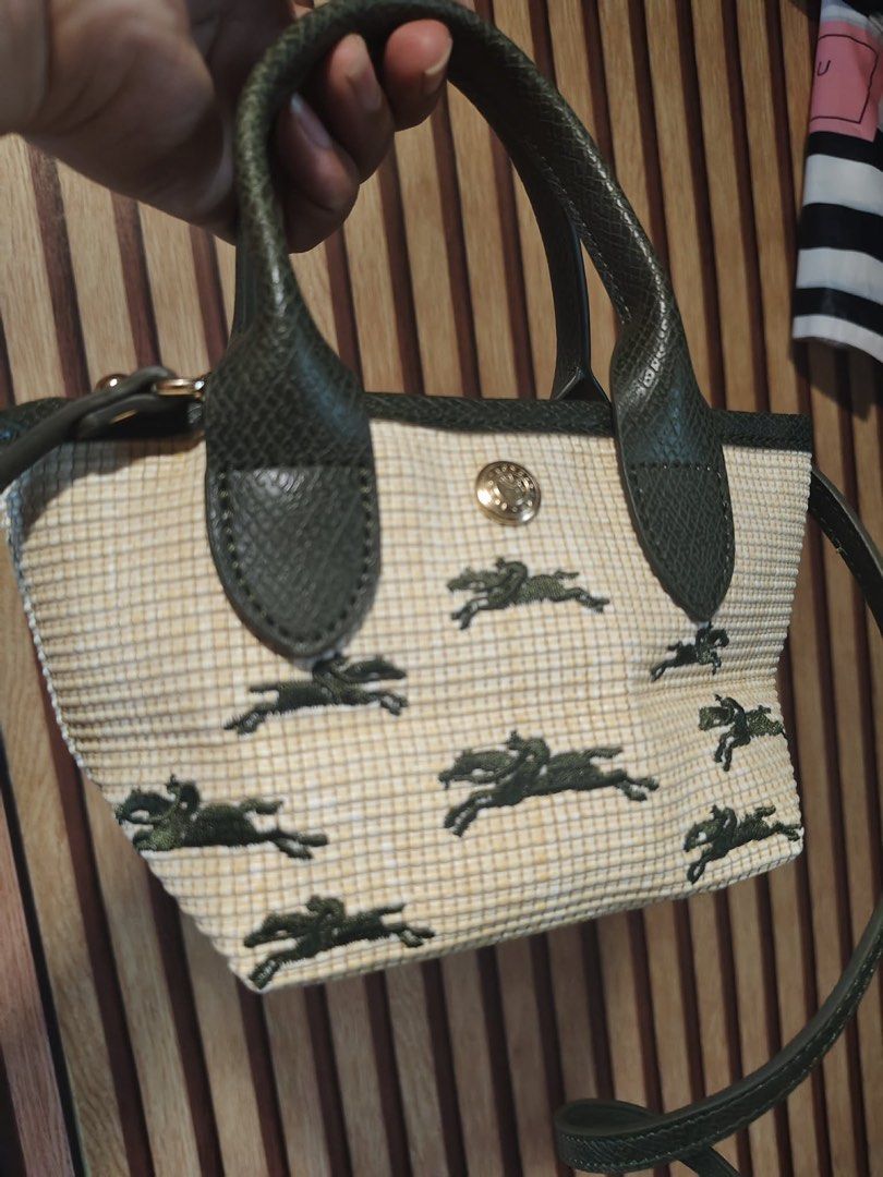 Longchamp Green Horse Pattern Mini Bag With Strap (Category: Luxury Bags & Wallets) located in Manila. Submitted by gmargareth (Listing ID 1470888686, Image 2). Description: - Authentic Longchamp mini crossbody bag - Cream and yellow woven fabric body with dark green leather handles and strap - Elegant gold hardware with a secure clasp closure - Structured rectangular base to hold its shape - Iconic repeating horse and rider pattern printed insid