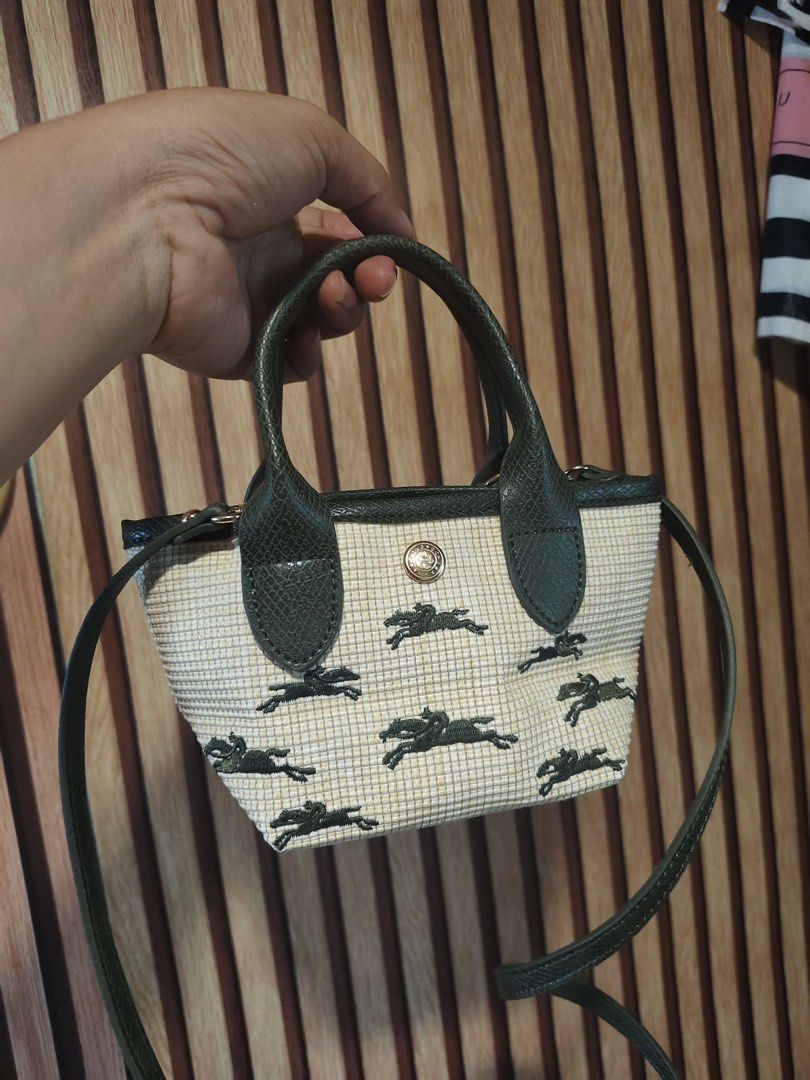 Longchamp Green Horse Pattern Mini Bag With Strap (Category: Luxury Bags & Wallets) located in Manila. Submitted by gmargareth (Listing ID 1470888686, Image 1). Description: - Authentic Longchamp mini crossbody bag - Cream and yellow woven fabric body with dark green leather handles and strap - Elegant gold hardware with a secure clasp closure - Structured rectangular base to hold its shape - Iconic repeating horse and rider pattern printed insid