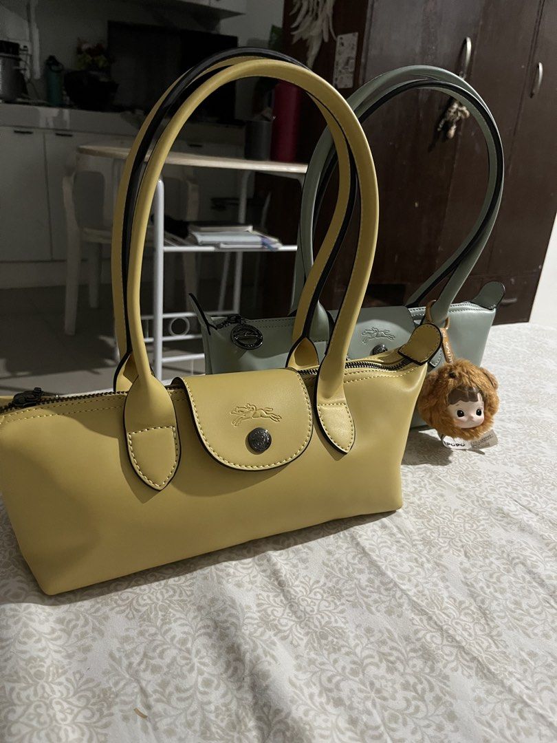 Longchamp Le Pliage Extra Small Handbag Yellow and Mint Green (Category: Luxury Bags & Wallets) located in Manila. Submitted by mightywater.250f83 (Listing ID 1470845546, Image 1). Description: - Authentic Longchamp handbags available in 2 colors: Yellow and Mint Green - Condition: Clean, hardly used, and well-maintained - Features: Secure zipper closure with button flap snap and double top handles - Interior: Clean black jacquard fabric lining w