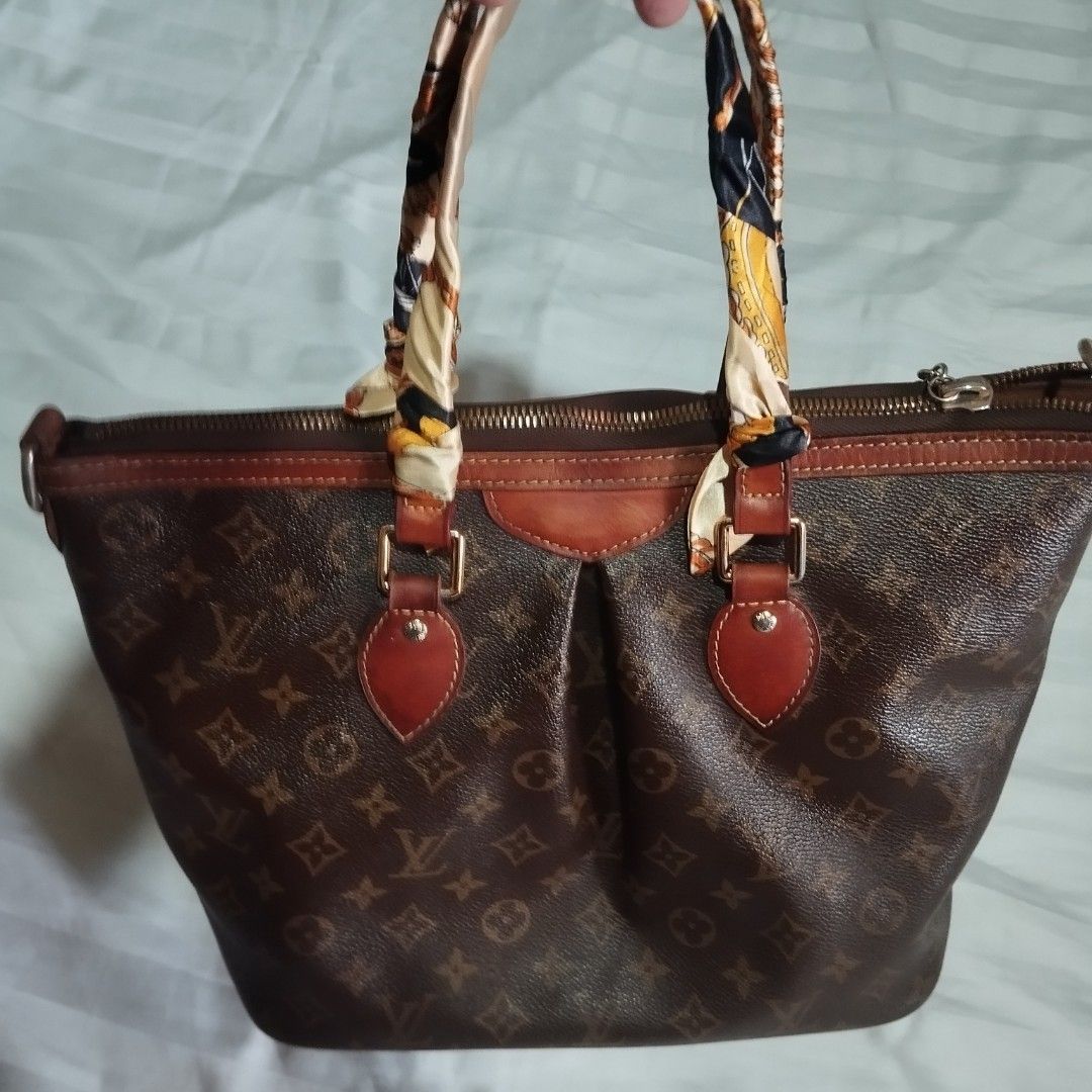 Louis Vuitton Monogram Canvas Tote Bag (Category: Tote Bags) located in Manila. Submitted by lene48 (Listing ID 1470801466, Image 2). Description: - Louis Vuitton monogram canvas tote - Features clean brown coated canvas body with minimal wear - Secure zip top closure to keep your belongings safe - Structured leather-trimmed handles wrapped with a stylish twilly scarf - Includes a signature hanging LV medallion charm on a chain - Spacious interio