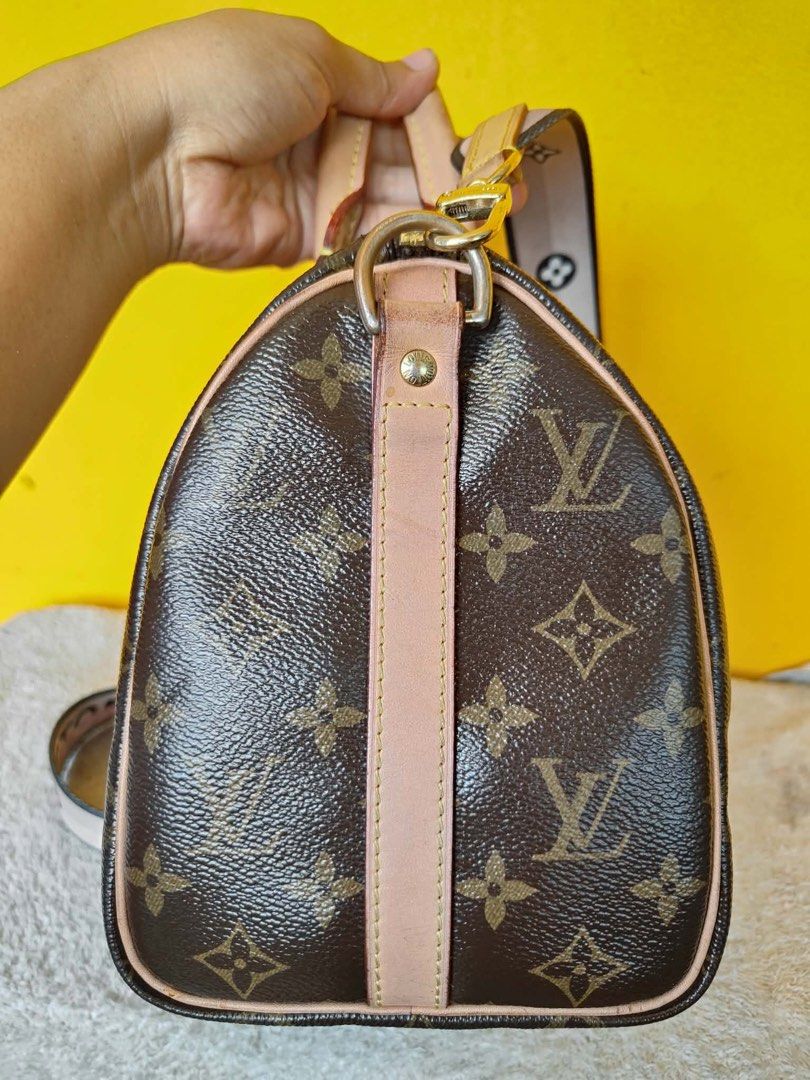 Louis Vuitton Monogram Speedy Handbag with Strap and Charms (Category: Luxury Bags & Wallets) located in Alburquerque. Submitted by wildforest.ea4e9c (Listing ID 1470821775, Image 3). Description: - Authentic Louis Vuitton Monogram Canvas Handbag in classic brown - Premium tan leather handles, side piping, and side tabs - Gleaming gold-tone hardware with dual LV zipper pulls for the top zip closure - Includes a trendy detachable fabric shoulder s