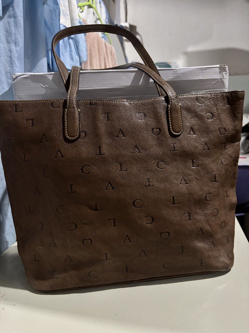 LOVCAT Brown Leather Monogram Tote Bag with Charm (Category: Tote Bags) located in Rizal. Submitted by va_nes_sa_ (Listing ID 1470820140, Image 2). Description: - Brand: LOVCAT RARE ITEM - Material: Premium brown leather with signature letter and heart monogram print - Handles: Double top handles for easy shoulder or hand carry - Hardware: Elegant gold-tone hardware - Special Feature: Gorgeous decorative charm with hearts and a large faceted crys