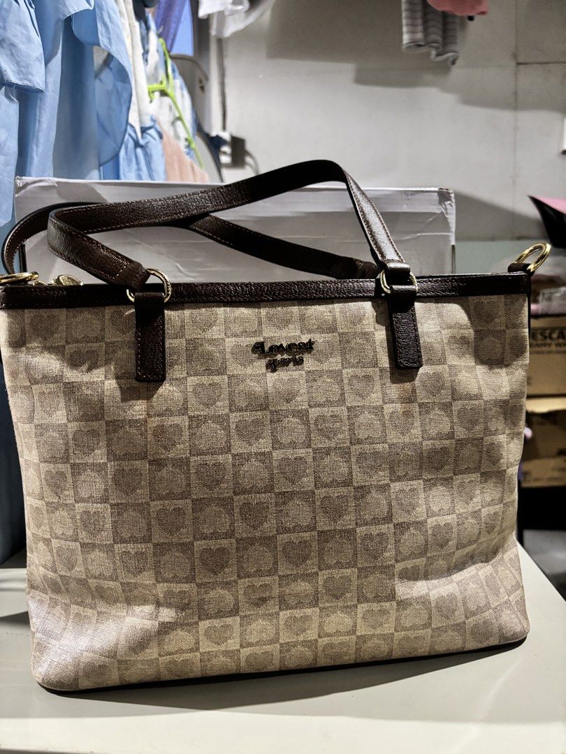Lovecat Paris Checkered Heart Tote Bag (Category: Tote Bags) located in Rizal. Submitted by va_nes_sa_ (Listing ID 1470820630, Image 1). Description: - Brand: Lovecat Paris - Design: Beige and brown checkered pattern with subtle heart prints inside the squares - Straps & Trim: Dark brown leather-look shoulder straps - Hardware: Gold-tone hardware with a cute heart-shaped stud detail near the handle base - Branding: Metallic gold brand lettering o