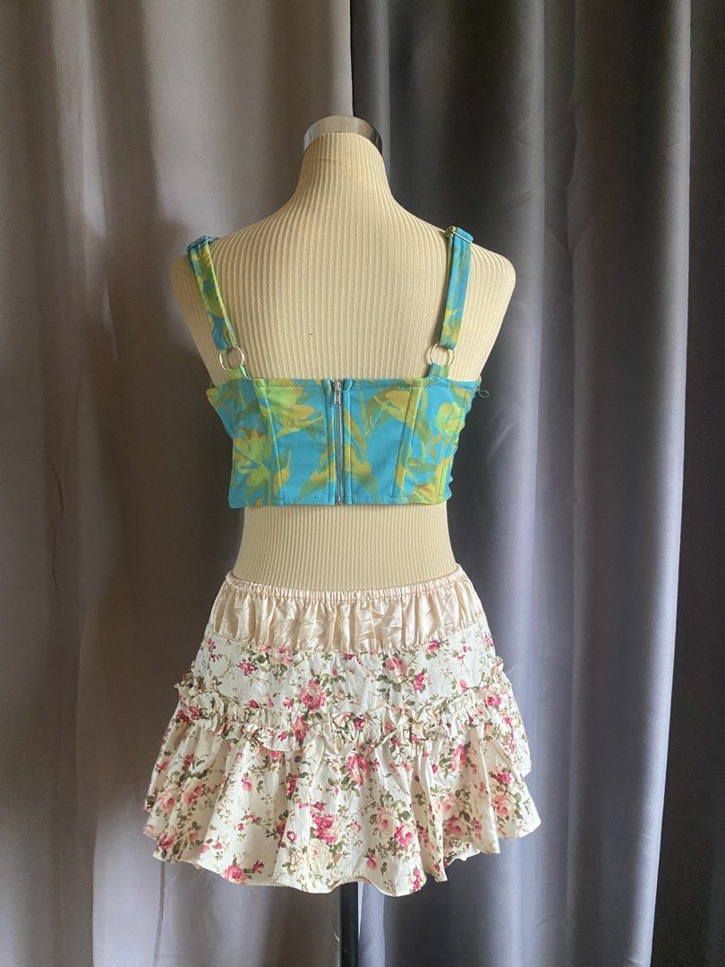 Luck & Trouble Teal Abstract Print Corset Top (Category: Sleeveless) located in Cagayan de Oro. Submitted by curated_closetph (Listing ID 1470745595, Image 3). Description: — Size: S - M — Color: Teal / Multicolored — Structured cotton-blend fabric with vibrant abstract pattern — Square neckline with wide tank-style shoulder straps — Vertical boning details along the bodice — Curved asymmetrical hem — Exposed back zipper closure — Can negotiate t